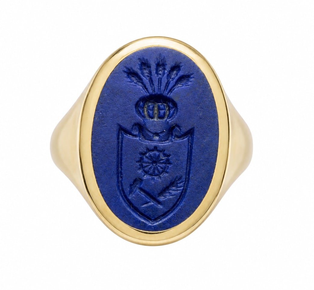 LAPIS LAZULI SIGNET RING: LAPIS LAZULI SIGNET RING,9.8 grams, testing 18 ct. gold.The carved lapis lazuli seal with a heraldic crest.Size I 1/2.