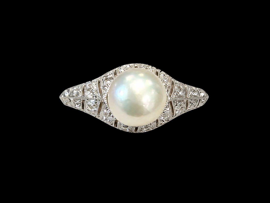 EDWARDIAN PEARL AND DIAMOND RING: EDWARDIAN PEARL AND DIAMOND RING,testing 18 ct. gold and platinum.Lovely pearl of approx. 6.45 mm. (untested, believed to be natural).Diamonds bright and lively.Size N 1/2.