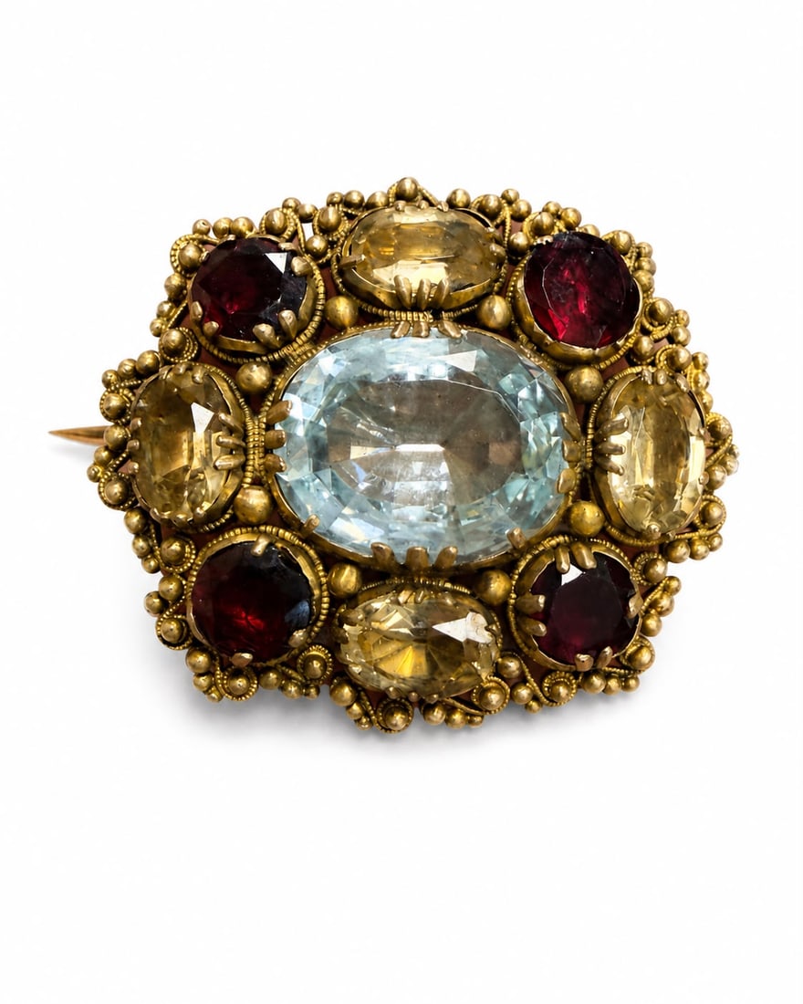 GEORGIAN AQUAMARINE, GARNET AND TOPAZ BROOCH: GEORGIAN AQUAMARINE, GARNET AND TOPAZ BROOCH,9.1 grams, testing 18 ct. gold.Set with an aquamarine of approx. 4.50 ct.Topaz alternated with garnets.Topaz totalling approx. 2.70 ct.W. 3.1 cm.