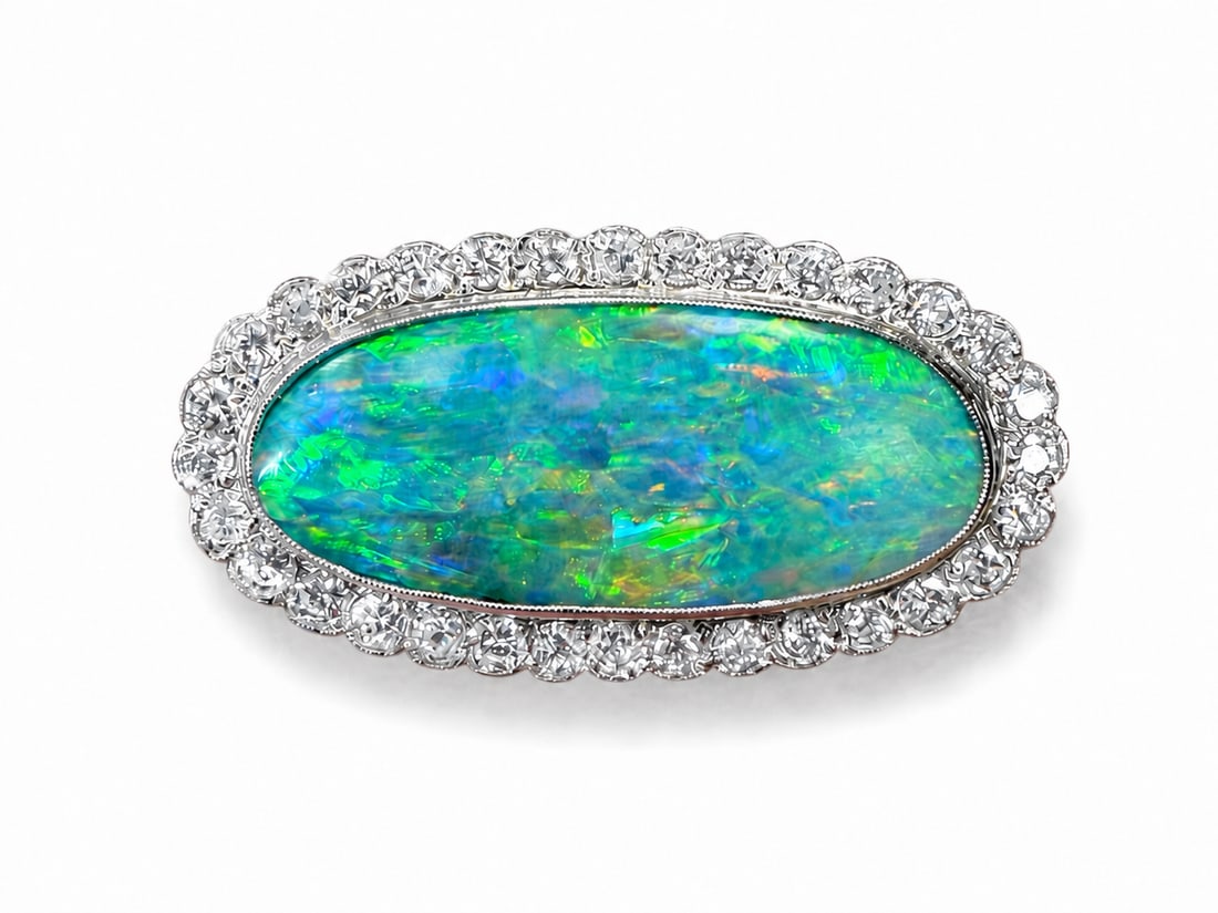 OPAL AND DIAMOND BROOCH: OPAL AND DIAMOND BROOCH,7.,4 grams, testing high carat gold.Rich and vibrant opal with god pay of colour including red, of approx. 11.50 ct.Diamonds bright and lively, totalling approx. 1.30 ct.L.