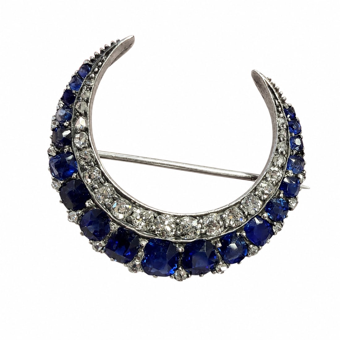 VICTORIAN SAPPHIRE AND DIAMOND CRESCENT BROOCH: VICTORIAN SAPPHIRE AND DIAMOND CRESCENT BROOCH,6 grams, testing high carat gold and silver.Rich and vibrant sapphires.Diamonds bright and lively.W. 3.2 cm.