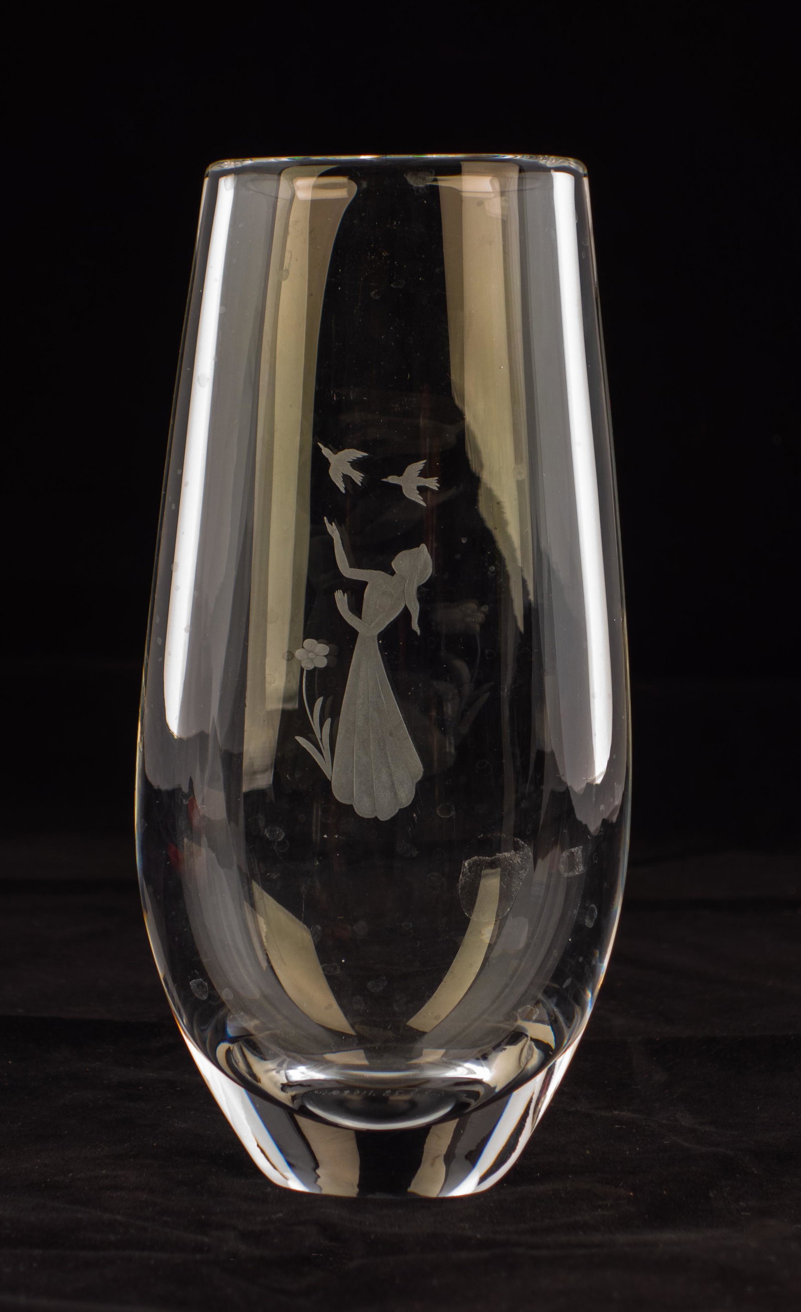 Orrefors Art Glass Vase: Etched Orrefors vase with maiden amongst flowers with birds overhead. Signed as shown. 9"X 3.25" opening 2"