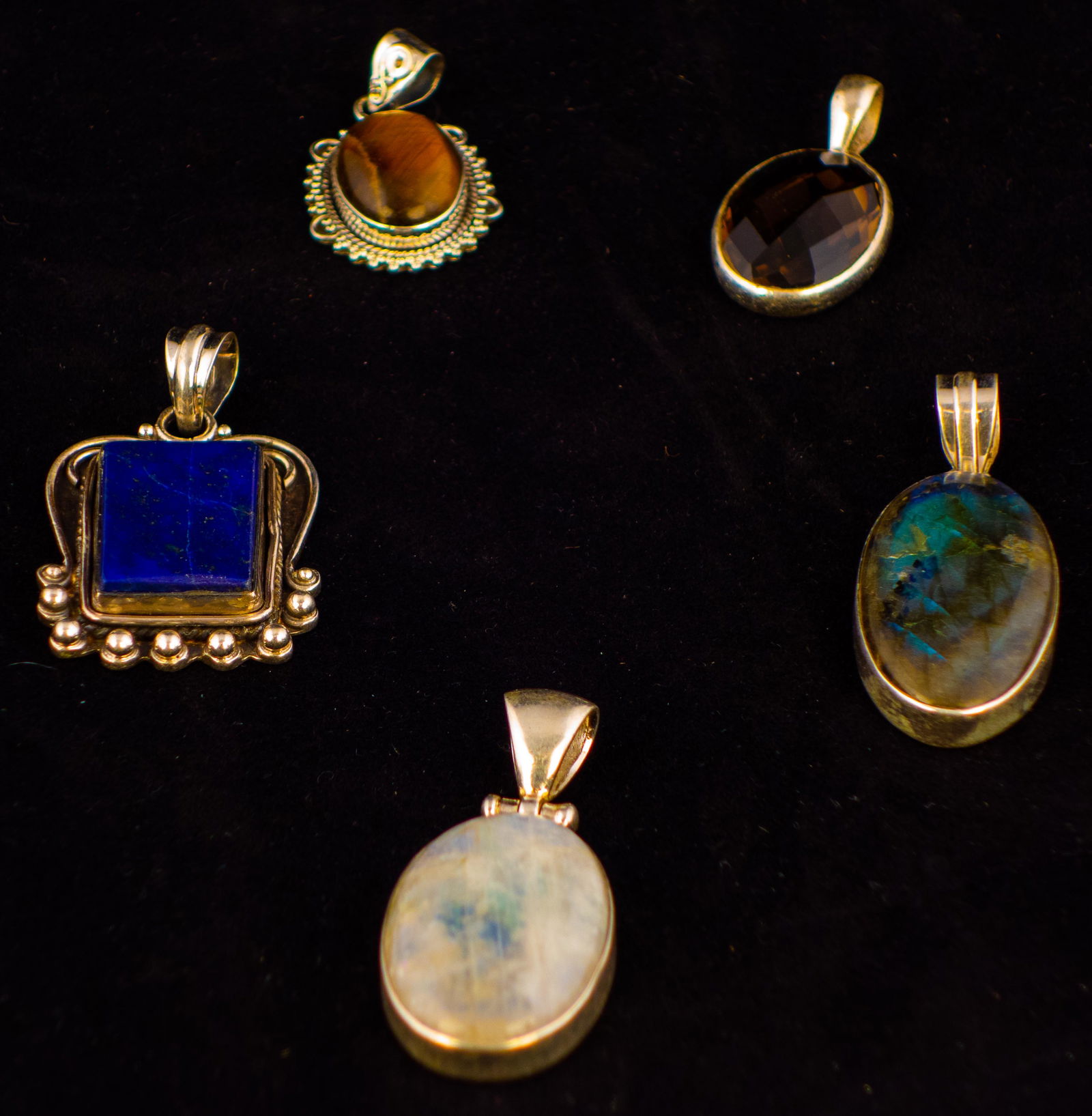 Lot of 5 Sterling Silver Pendants: Lot of 5 sterling silver pendants with various designs and gemstones including Lapus, Tigers Eye, Labradorite. Sizes up to 1.5". Total weight 48.8 grams.