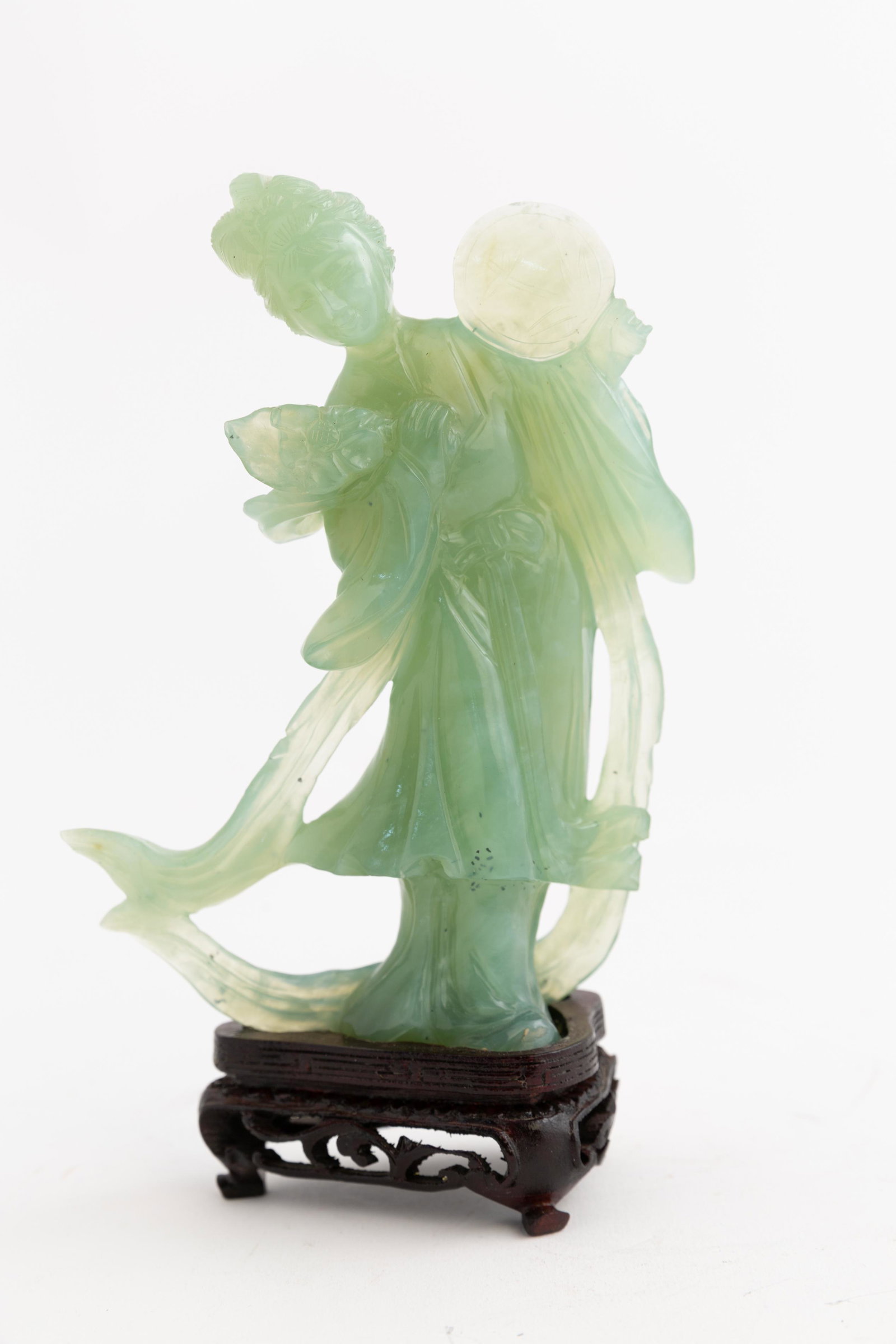 Chinese Carved Hardstone Woman: Chinese Carved Hardstone Woman on Hard Base. Translucent Pale Green with Detailed Carving of Fan and Flowing Robes. 7 1/2" high X 4 1/2" wide.