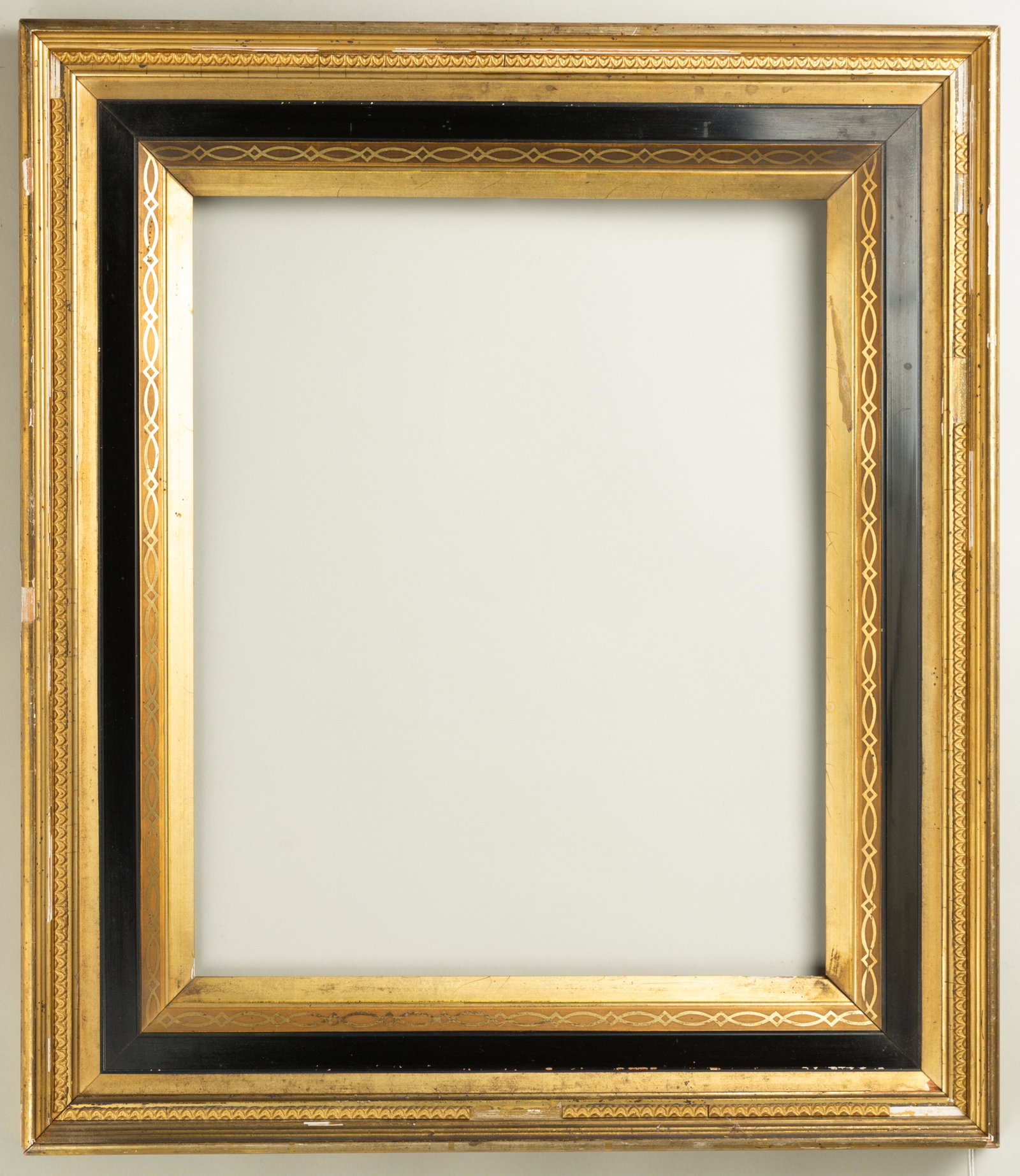 American Eastlake Gilt and Ebonized Frame: American, ca. 1880, bright lemon gold with stenciling and ebonized panel, matches lot 164. Rabbet: 14" x 17" Overall Dimensions: 20.5" x 23.5" Molding Width: 3.75"