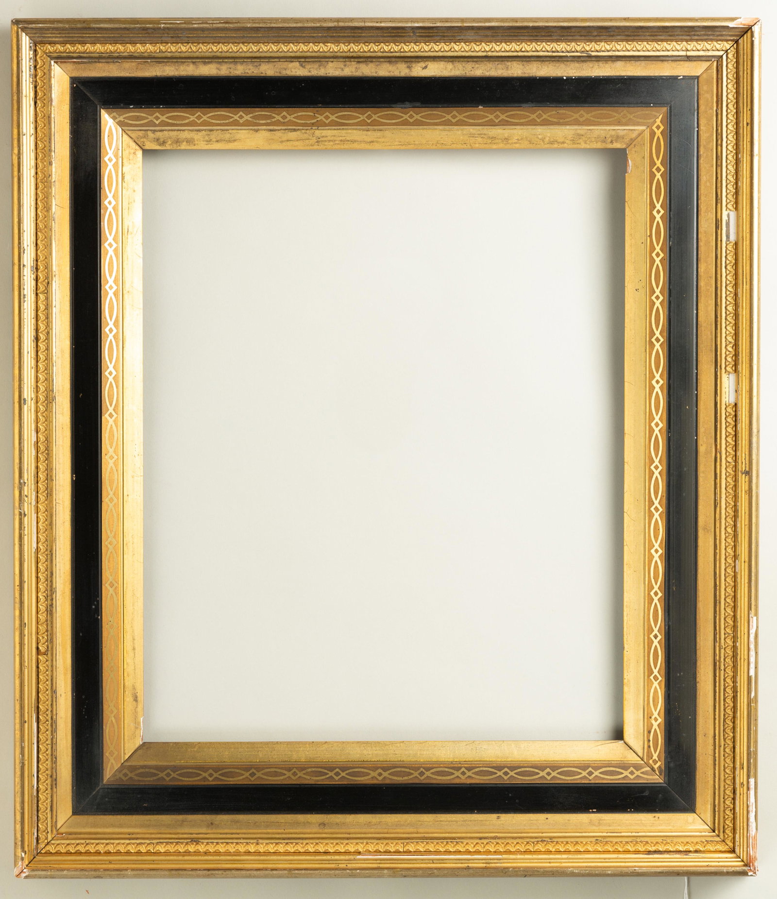 American Eastlake Gilt and Ebonized Frame: American, ca. 1880, bright lemon gold with stenciling and ebonized panel, matches lot 163. Rabbet: 14" x 17" Overall Dimensions: 20.5" x 23.5" Molding Width: 3.75"