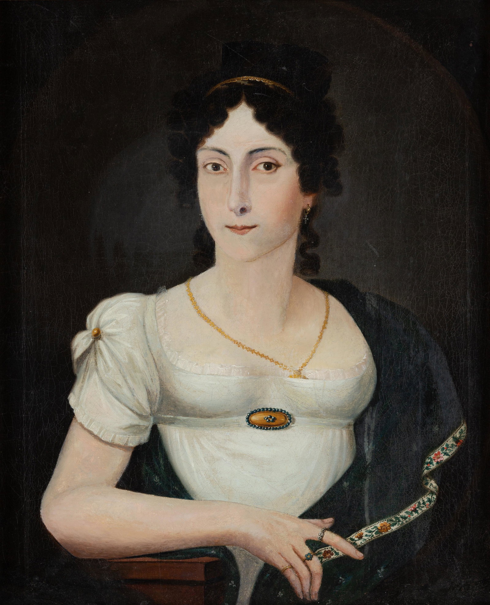 Portrait of a Lady: European, possibly American South, ca. 1820, oil on canvas depicts a lady with black curls, dark eyes, embroidered shawl, earrings, locket over her heart, brooch, and 3 rings including one on her fore