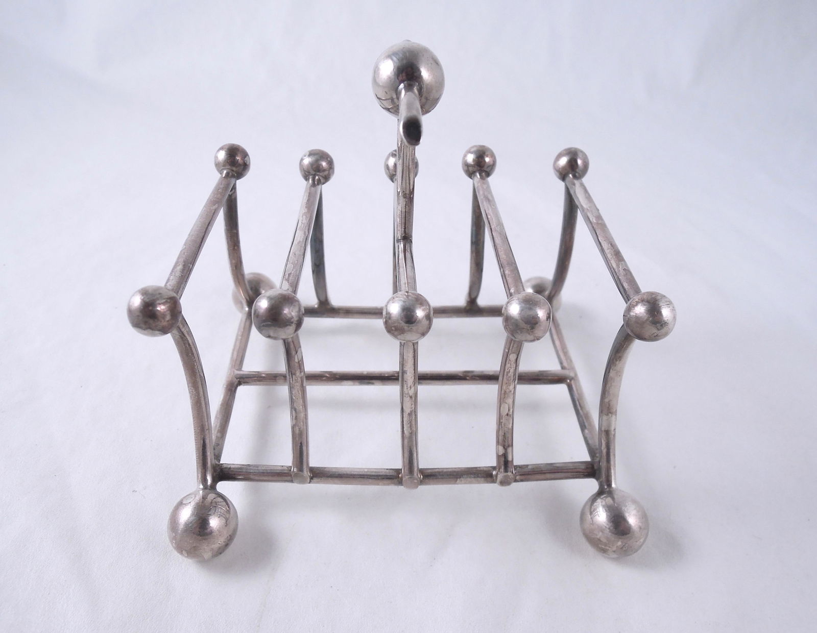 Christopher Dresser Style Toast Rack: English Silverplate of Dynamic Form. 4 1/8". Hallmarked as shown.