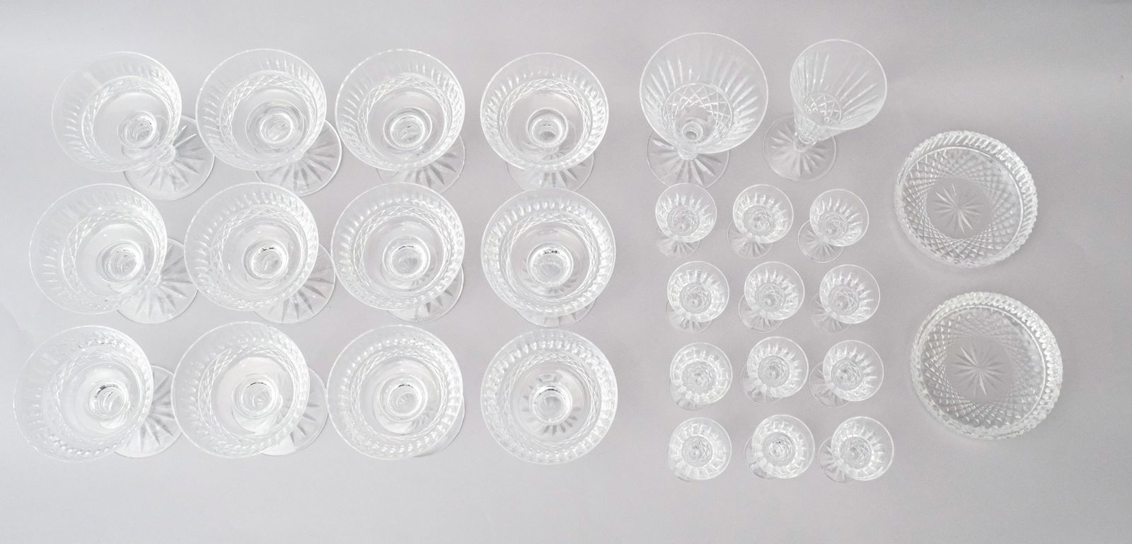 Lot of 28 Waterford Tramore Crystal Stemware: Comprising 12 cordials, 12 champagne or sherbets, 1 water goblet, 1 champagne flutes, 2 wine coasters. Marked Waterford. Cordial 3" Champagne or Sherbet 4 1/2" Water Goblet 5 5/8" Champagne Flute 6 1/