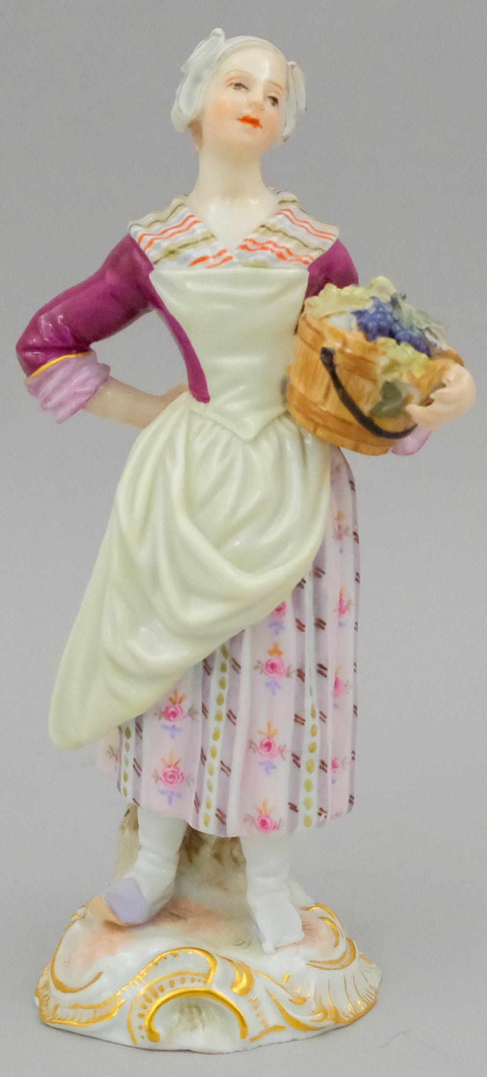 Meissen Porcelain Figurine of Maiden: Beautifully depicted holding bucket of grapes with incised numbers and factory first mark, 5" tall.
