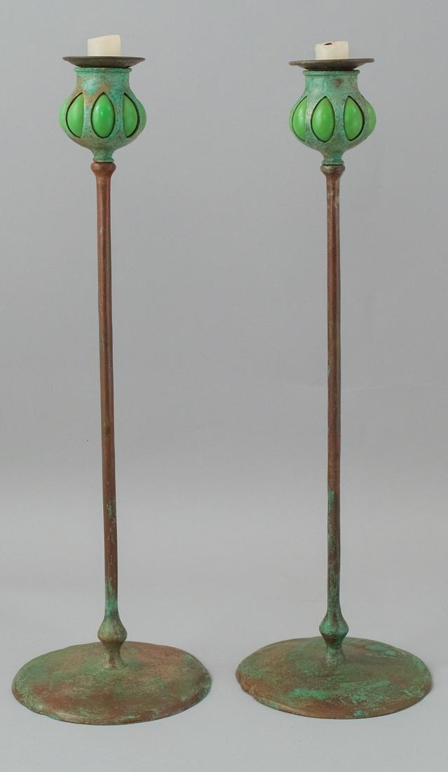 Pair Arts & Crafts Bronze and Glass Candle Sticks: Patinated bronze finish with blown out green glass at top and removable bobeche. With impressed mark Tiffany Studios New York 17" tall.