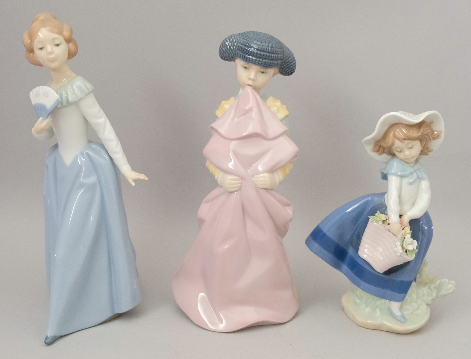 Group of 3 Lladro Figurines: Including pretty pickings, Nao figurine woman with fan, timid torero the young bull fighter. Tallest 9 3/8"