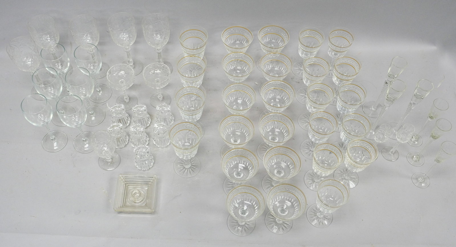 Large Group of Fine Stemware and Glass: Over 50 piece lot of fine quality stemware and glass containing stemmed wine glasses with dual gold bands, stemmed cocktail glasses with dual gold bands, stemmed water glasses with dual gold bands, fi