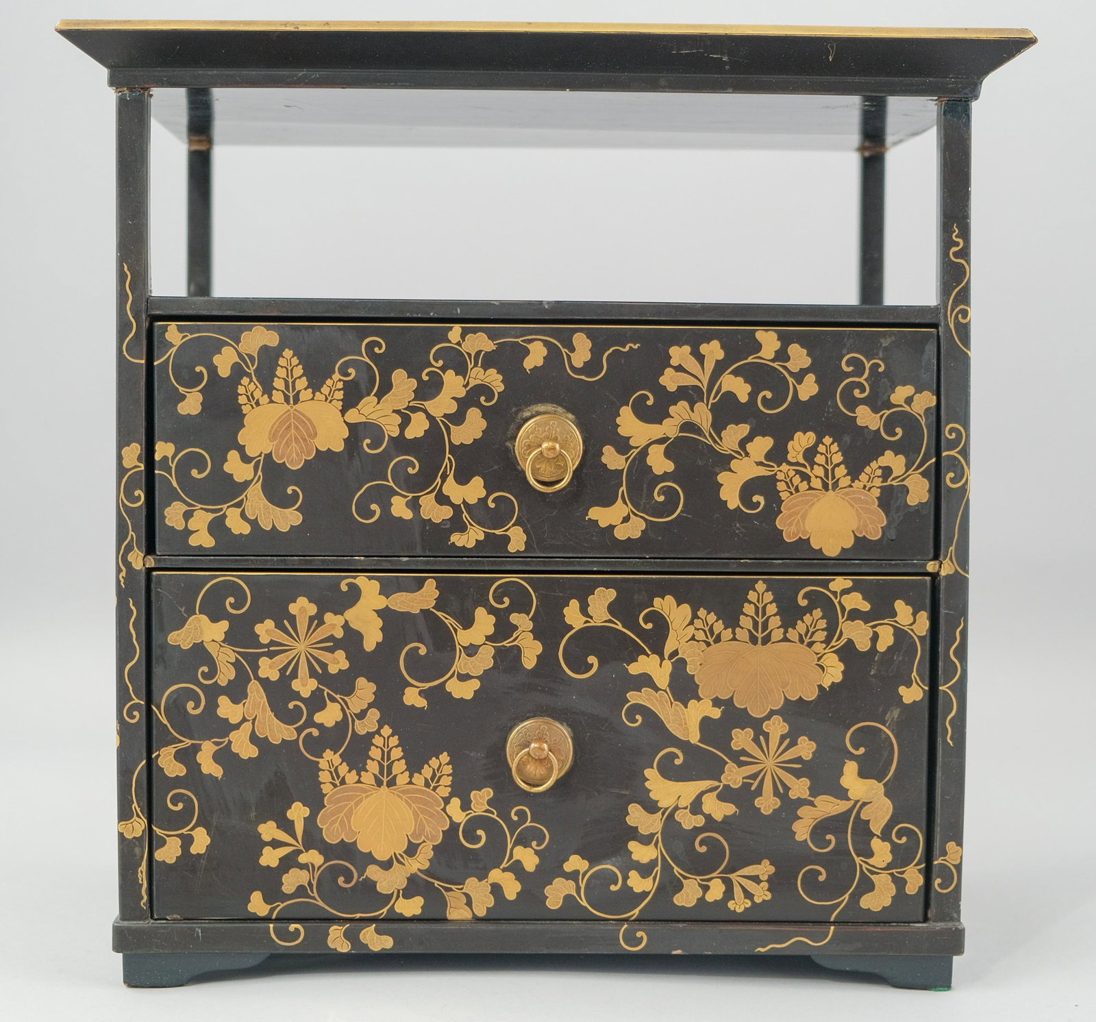 Japanese Lacquer and Gilt Jewelry Cabinet: Meiji period black lacquer cabinet with gold floral detailing. Shelf and tray above 2 drawers, 12 1/4" X 12 1/4"