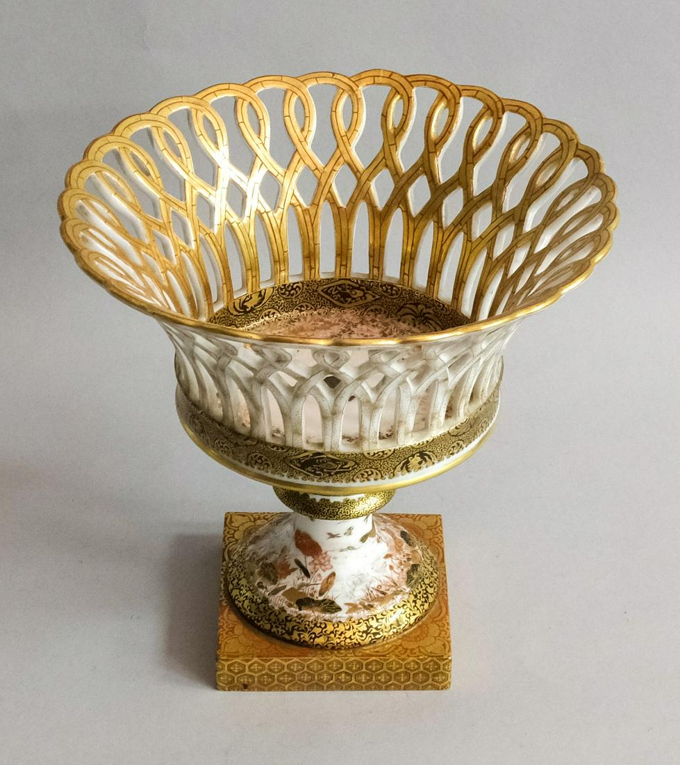 Antique Signed Kutani Japanese Porcelain Basket: Beautifully pierced basket on pedestal base, attached together with bolt. Black, red, and gold decoration all over of flowers, cranes and butterflies. Signed with red artist cipher on bottom. 8 7/8" x