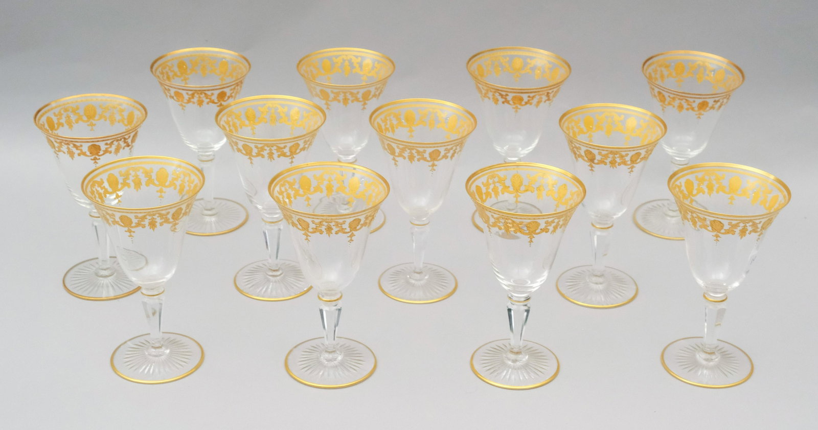 Set of 12 Moser Style Gold Encrusted Glasses: Set of 12 very fine wine or water glasses with gold encrusted filigree on rim and top, with gold bands at base and top of stem, 6" high.