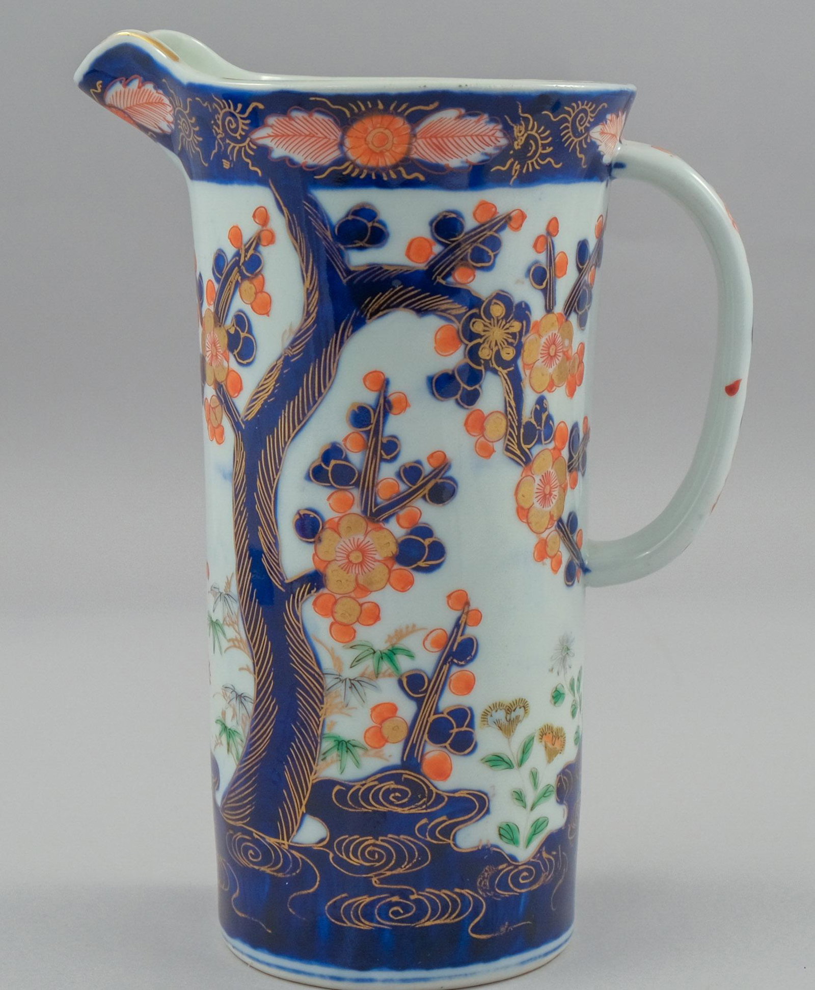 Antique Imari Porcelain Water Pitcher: Decorate din traditional pallet with cherry trees. Blue artist cipher mark on bottom, 9 1/4" tall.