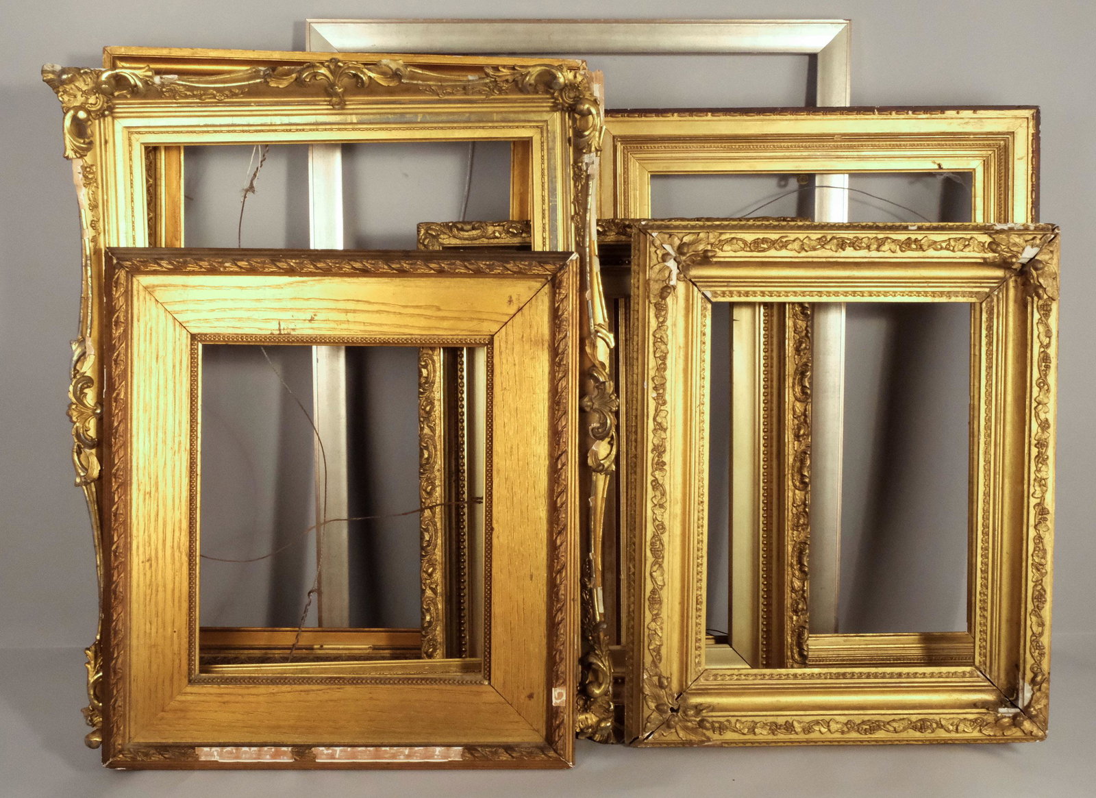 Lot of Seven Frames of Various Ages and Styles: American 19th and 20th centuries, including Hudson river school and modernist examples. Sizes range from rabbet 22" X 28" overall 24 3/4" X 30 3/4" to rabbet 10 1/2" X 16" overall 17" X 22"