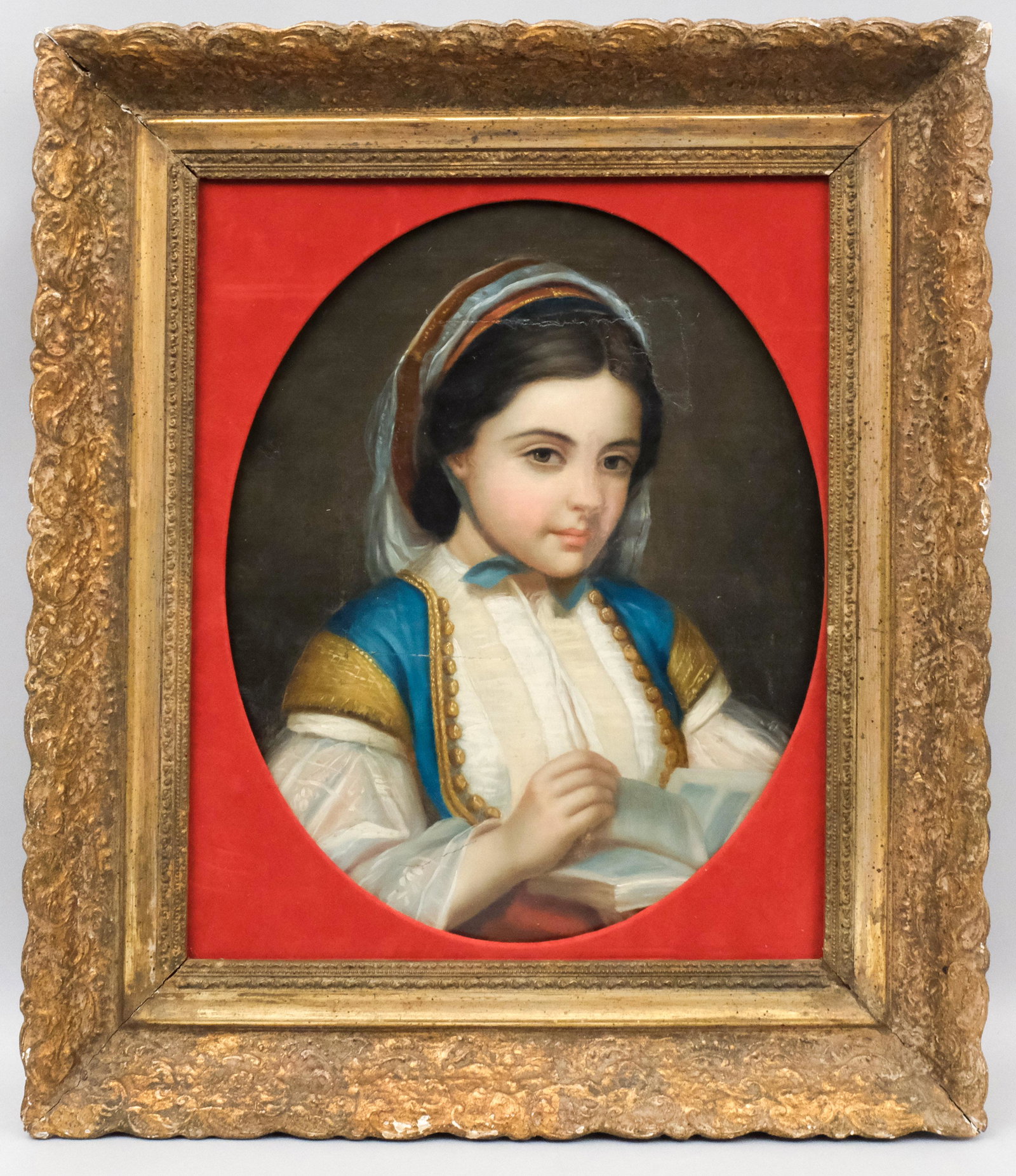 European School, 19th Century Portrait of a Girl: Possibly Italian or Spanish, ca. 1840, oil on canvas portrait of a young girl reading, housed in an antique frame with velvet spandrel, 18" x 21 1/4" canvas, 25" x 29 1/4" frame.
