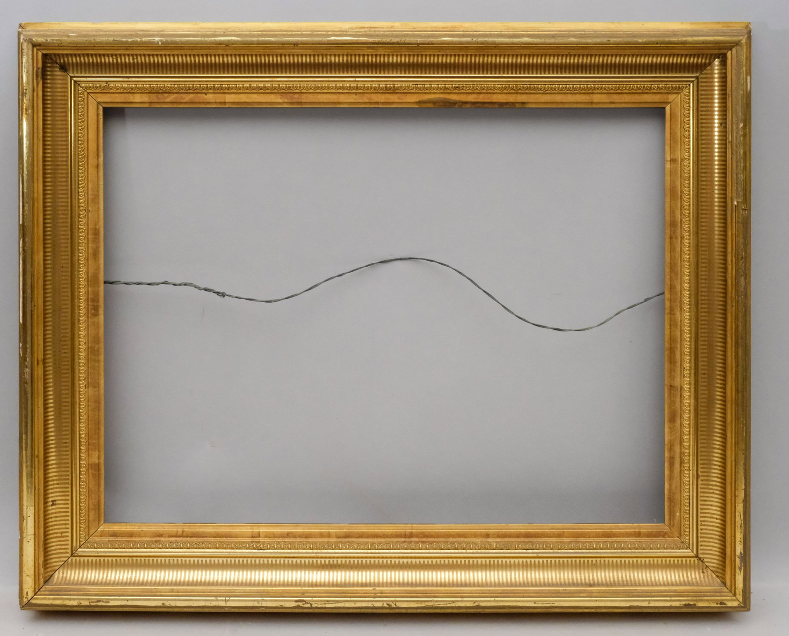 American Lemon Gold Stenciled Frame: American circa 1860 cove profile with fluted cove stencil decoration. One of a pair with lot 204. Rabbet 20" X 27" overall 27" X 34" molding 4"