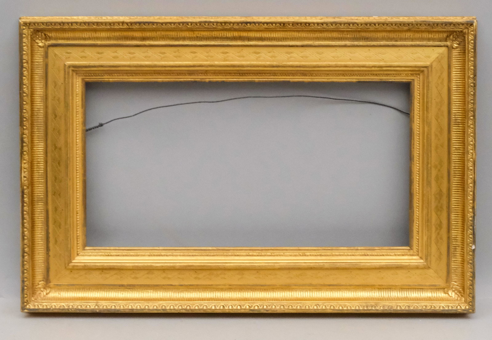 American Hudson River School Gifford Frame: American circa 1860. Burnished fluted cove with egg and dart top edge and incised panel liner of the style favored by Sanford Gifford. Rabbet 11" X 21" overall 18" X 28" molding width 4 1/4"