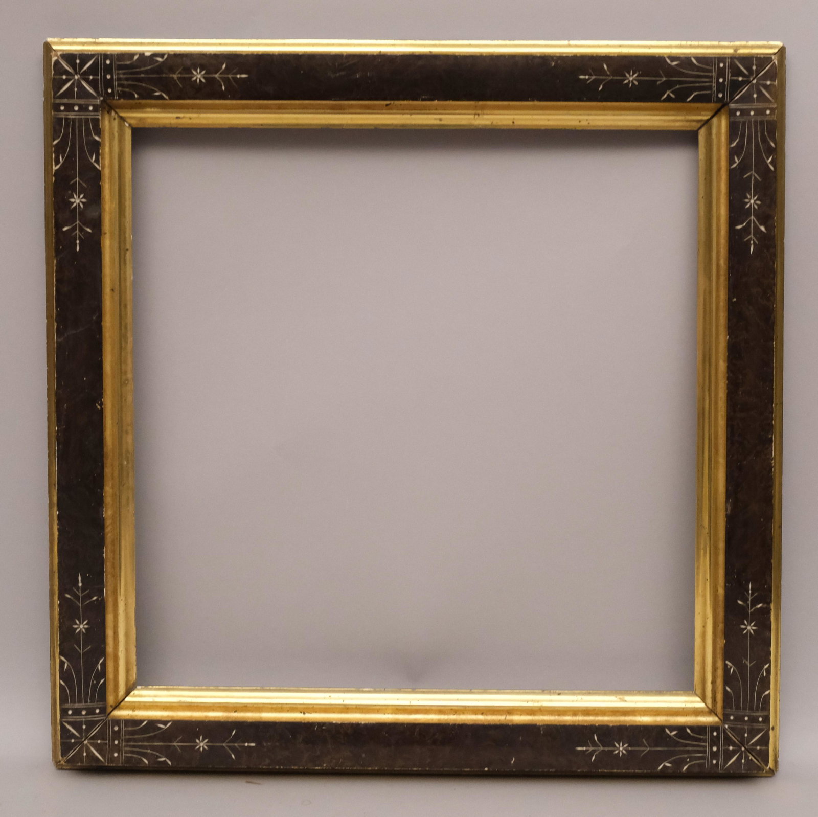 American Eastlake Lemon Gold and Faux Bois Frame: American, ca. 1870, gilded and incised. Rabbet: 16" x 16" Overall Dimensions: 20 1/4" x 20 1/4" Molding Width: 2 1/2"