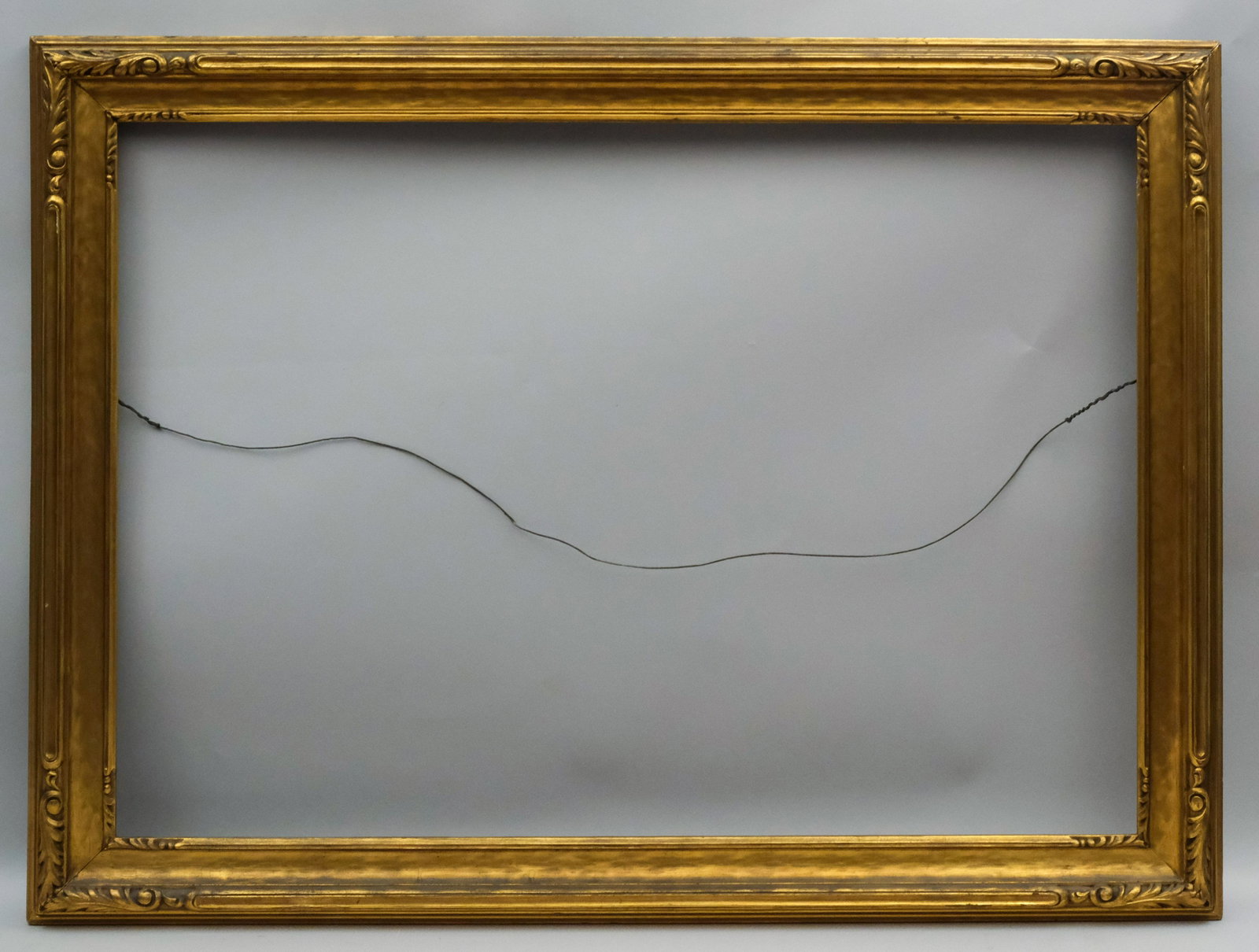 American Arts & Crafts Gilt Frame: American, ca. 1920, likely made by Newcomb Macklin, hand carved giltwood frame. Rabbet: 28" x 40" Overall Dimensions: 34 1/4" x 46 1/4" Molding Width: 3 1/2"