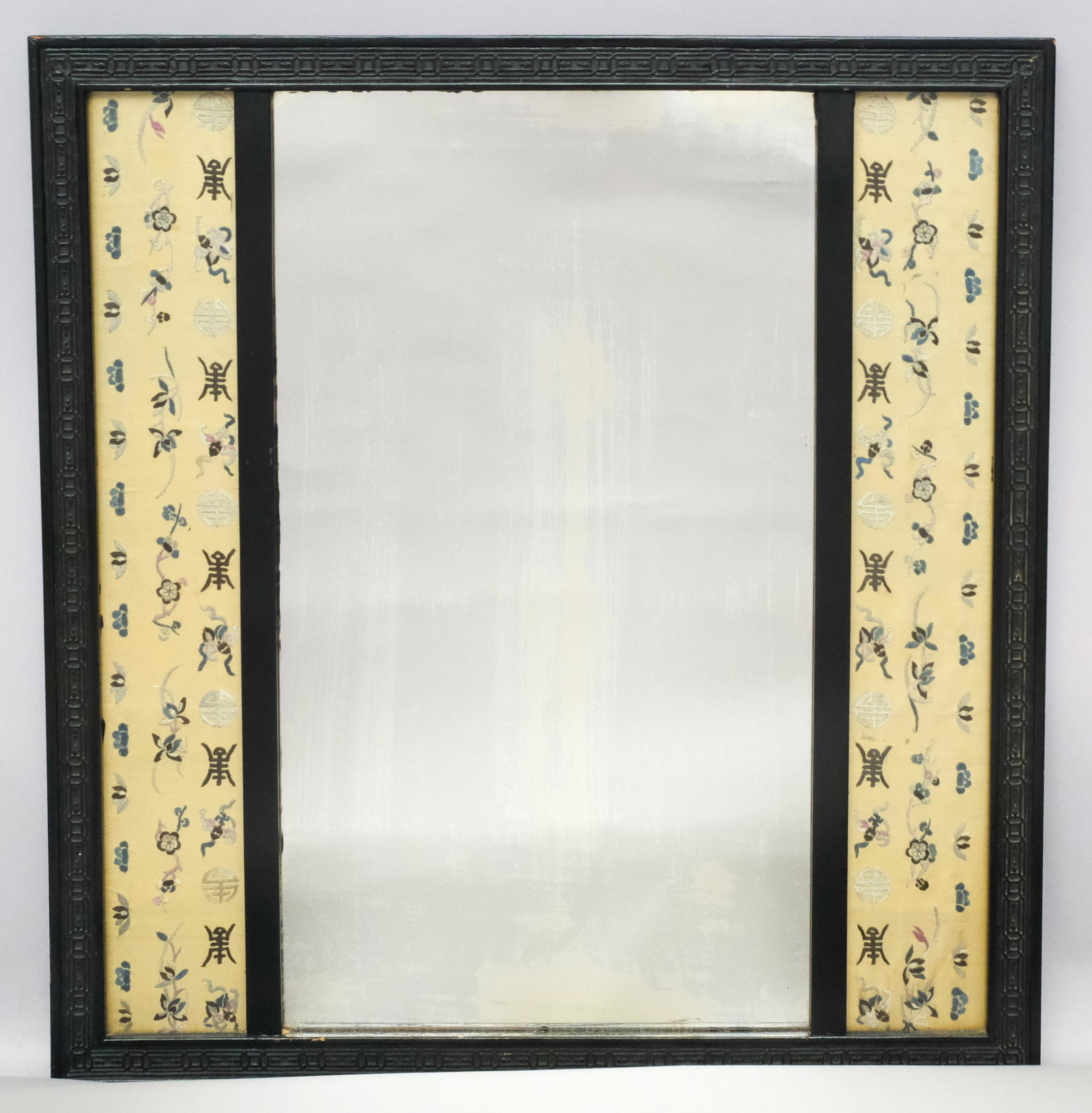 Antique Chinese Carved Wood and Silk Panel Mirror: Chinese export, ca. 1900, relief carved and lacquered frame, central rectangular distressed mirror flanked by embroidered silk panels under glass, 22 1/2" x 24" overall.