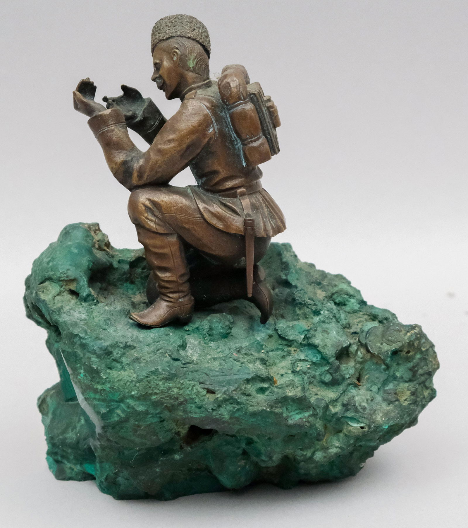 Russian Bronze of Soldier on Malachite Base: Realistically rendered in a kneeling position. Mounted on a craggy malachite base. 5 1/2" x 6". Unsigned