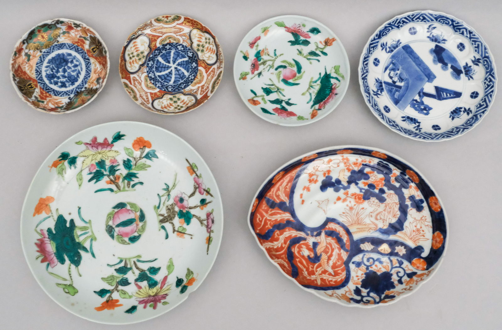 Lot of Asian Porcelain Including Imari & Peach: Including two peach plates, a blue and white plate, a wing form imari plate, and two small imari dishes. 4 5/8" to 8 5/8".