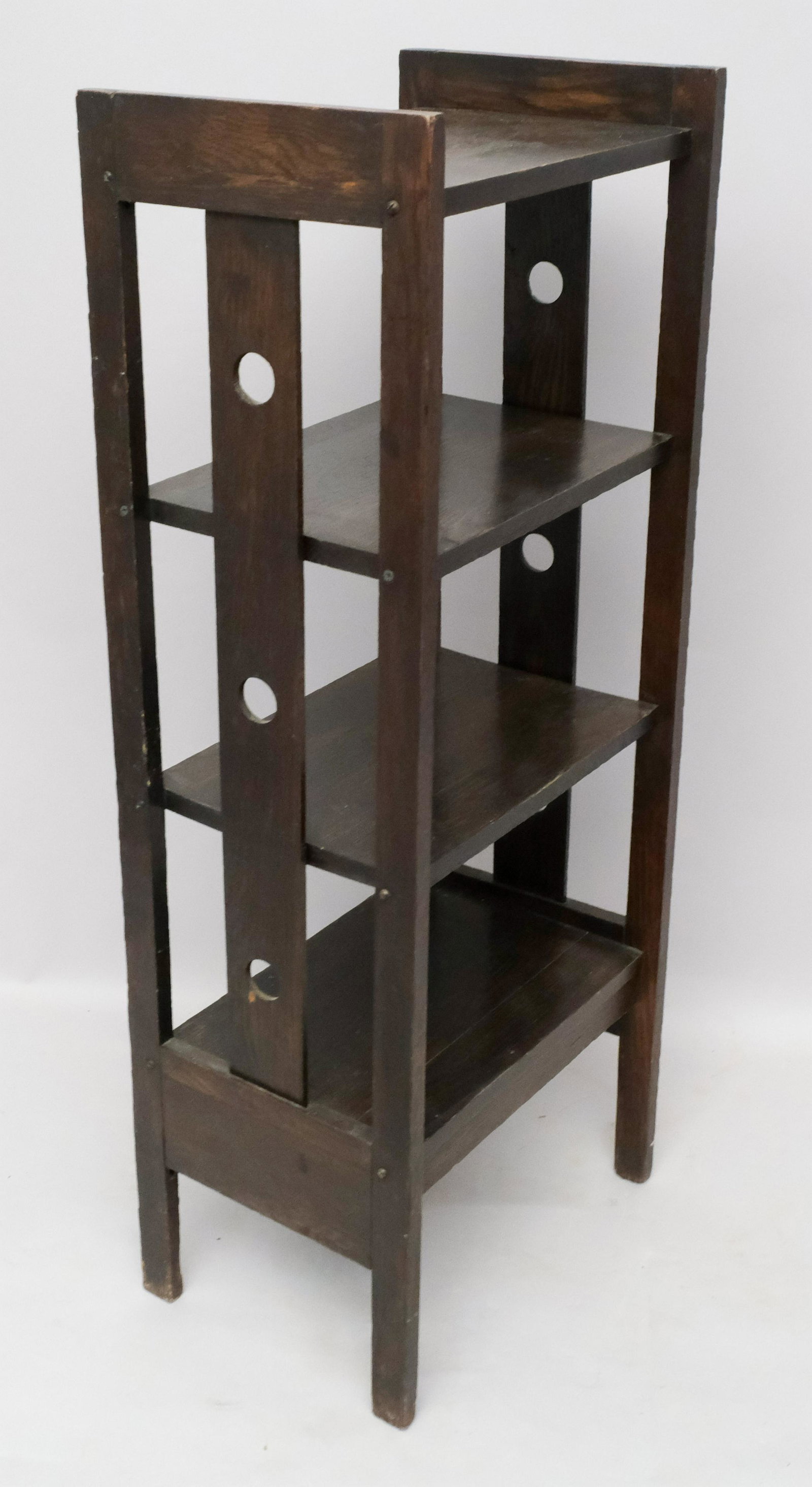 Arts & Crafts Mission Style Oak Bookshelf: Dark chocolate finish with pierced slats. Unmarked. 17 1/2" x 12 1/4" x 44".