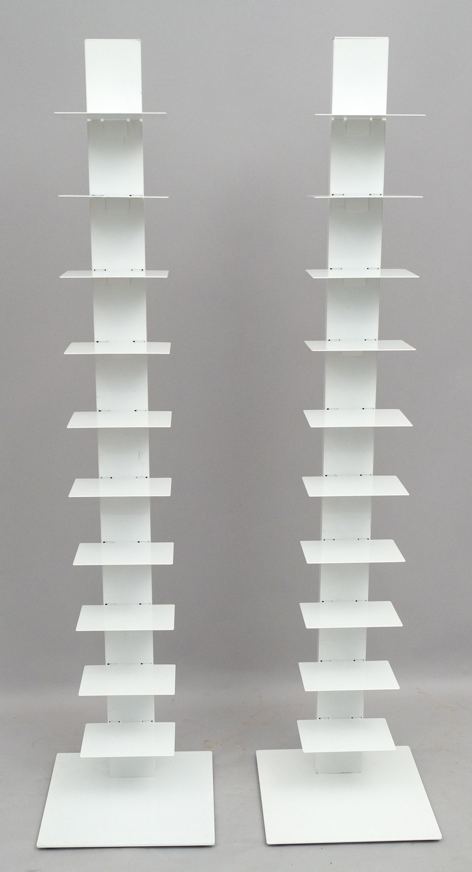 Pair West Elm Spine Bookcases: Pair of modern white metal spine bookcases by West Elm. 1 shelves on each freestanding bookcase. 60 " high 13 3/4" X 13 3/4" at base