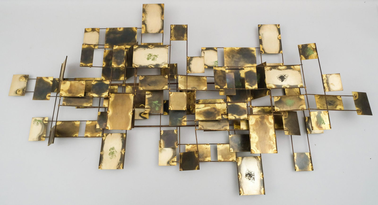 Curtis Jere Brutalist Mixed Metals Wall Sculpture: C. 1970. Geometric Floating Forms with patinated and verdigried surfaces. Signed lower right "C.Jere 70". 20 1/2" x 43".
