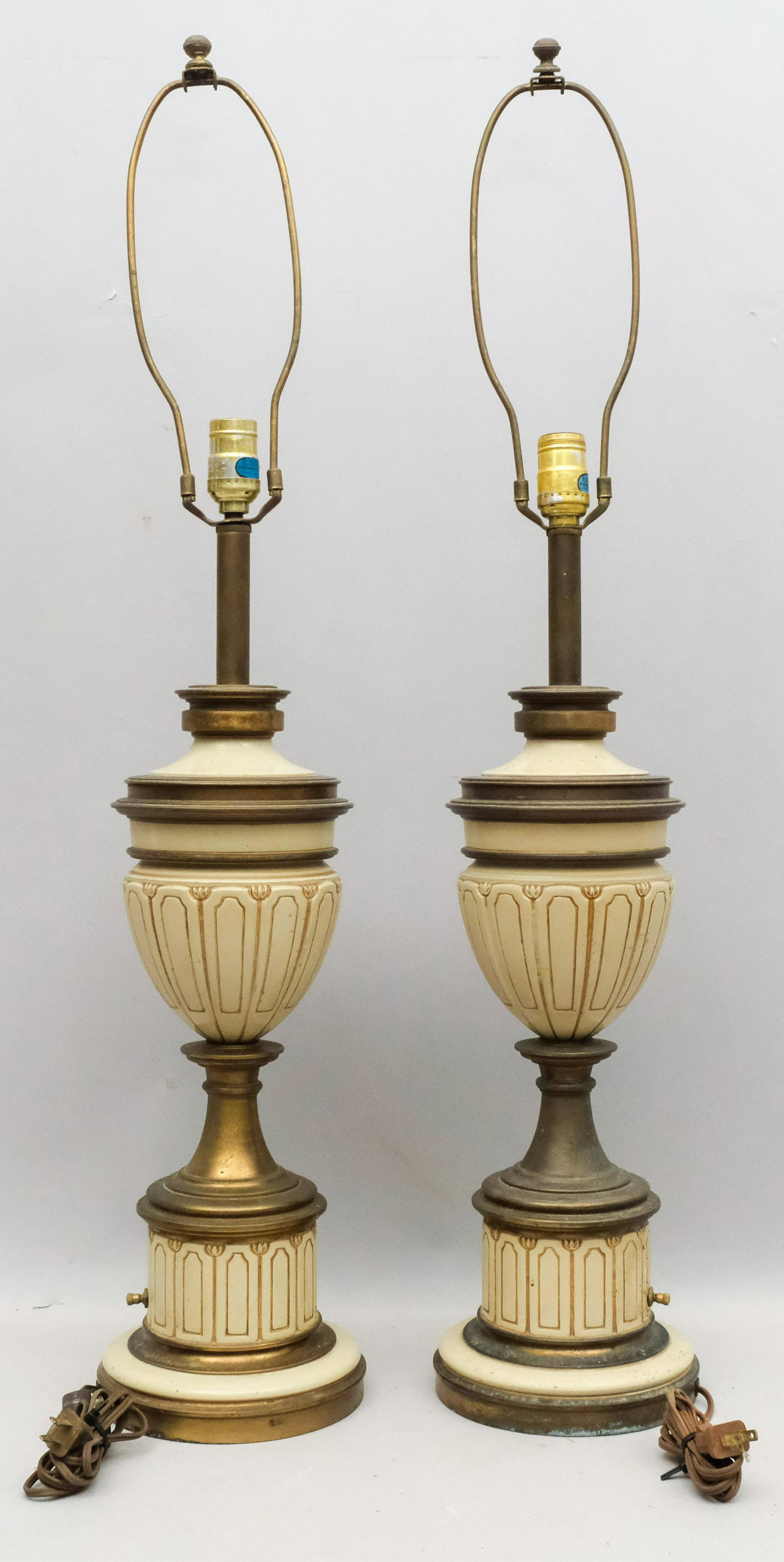Pair of Stiffel Neoclassical Style Lamps: Incised urn form with base and cord switches. Labels intact. 35 1/2" with harp.