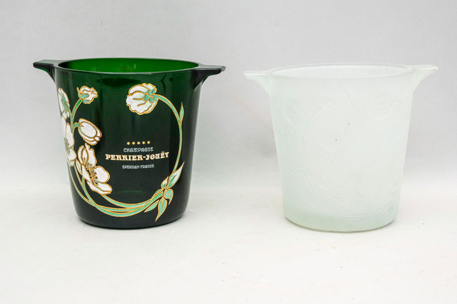 2 Belle Epoque Perrier Jouet Champagne Buckets: Comprising one in white monotone frosted glass and a bottle green version with polychrome enameling and gilt decoration. 7 7/8" x 91 1/2".