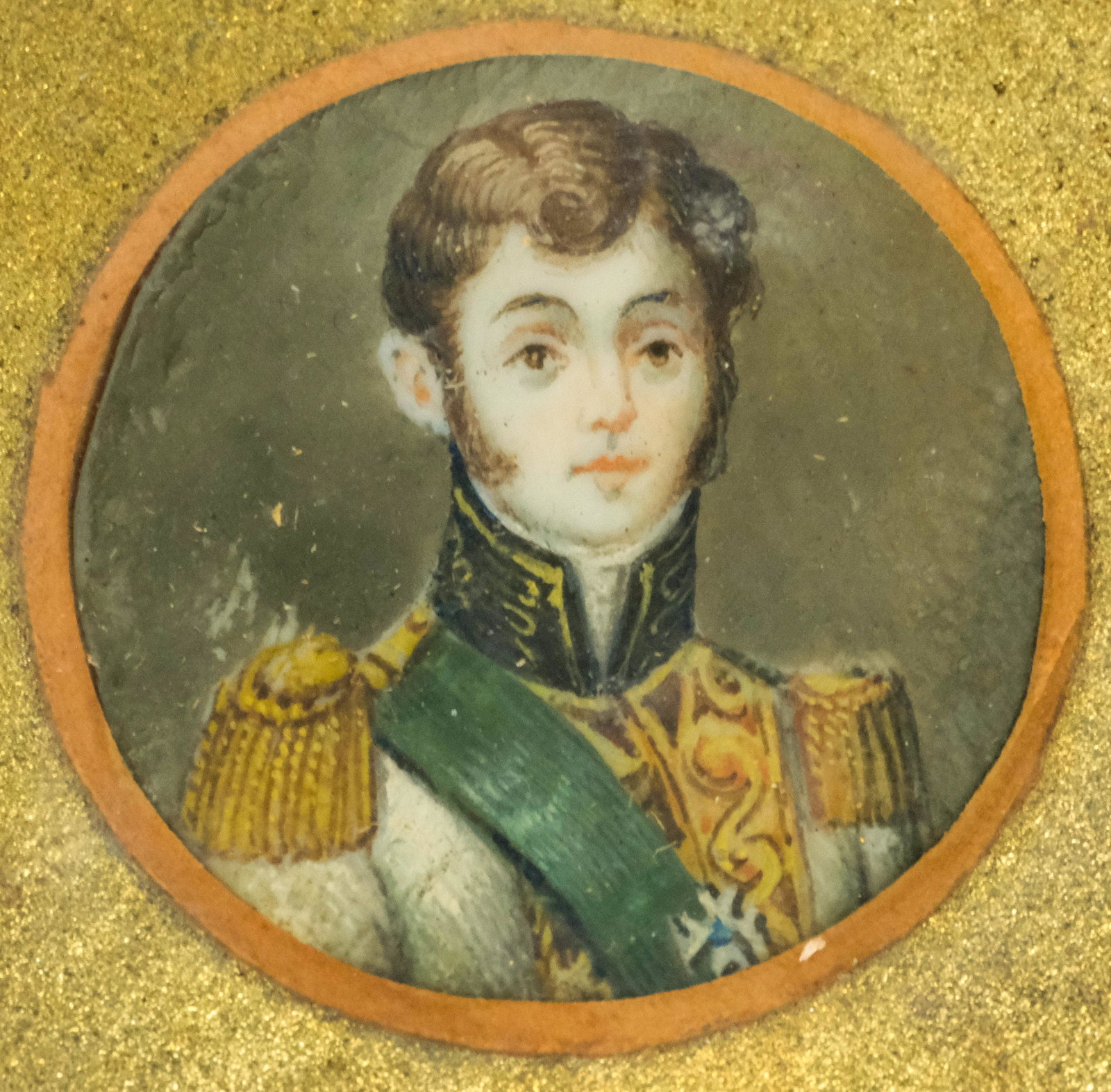 Framed Portrait Miniature of a Soldier: Continental, 19th Century. Depicting a very young soldier in dress uniform with sash, housed in bronze ormolu frame. Image size 1", overall 2 3/4" x 3 3/4".