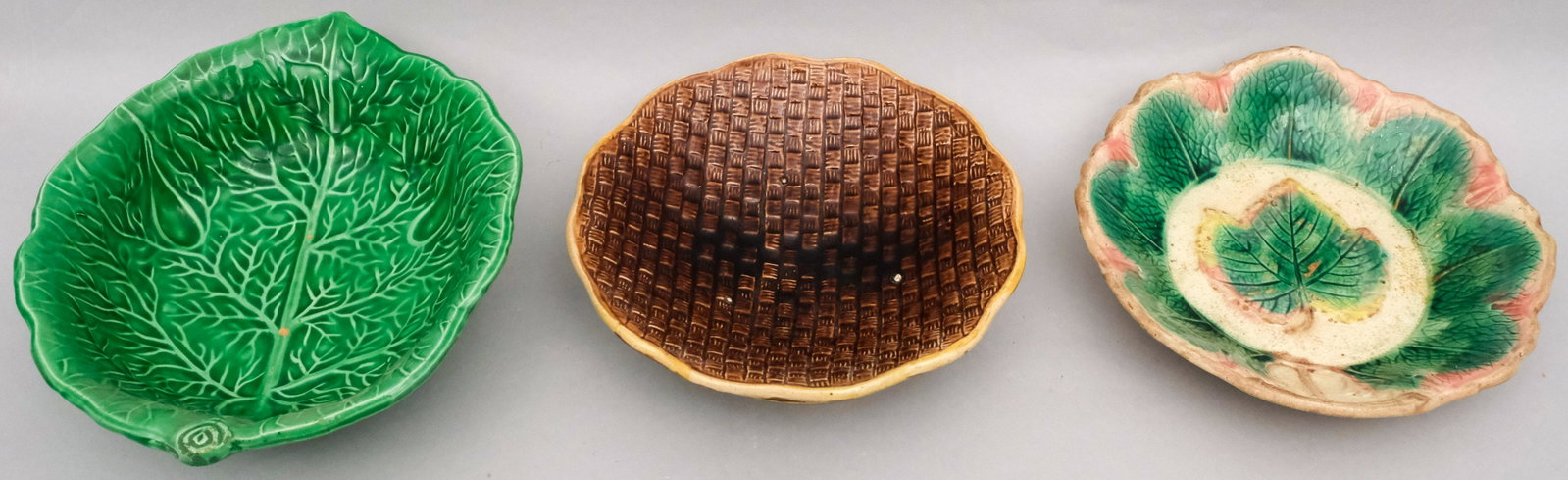 3 Piece Lot of Majolica, Etruscan and Others: Comprising two pieces attributed to Etruscan, including a basket weave footed bowl and a maple leaf shallow bowl, together with a green cabbage leaf bowl. 9 3/4" to 12 1/4".