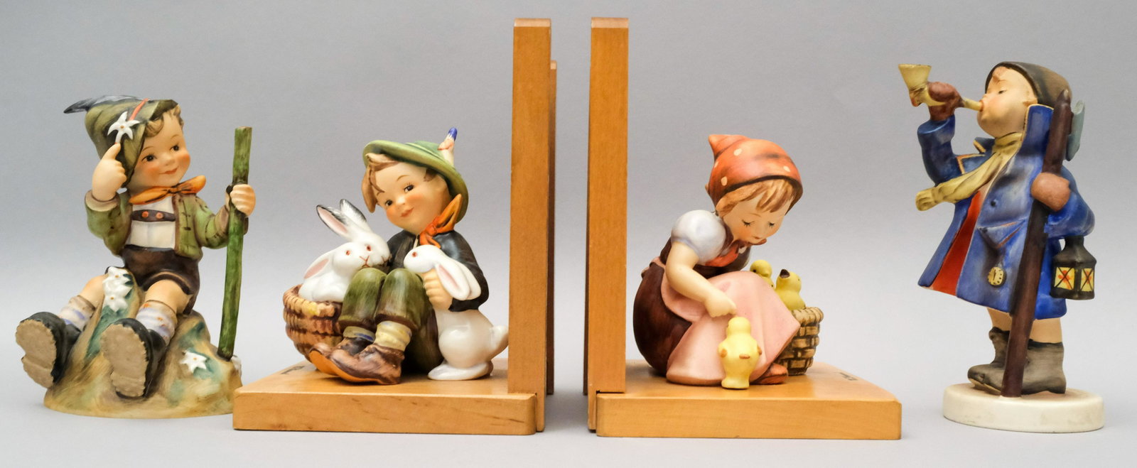 Lot of Hummel Figurines: Including a pair of bookends. All marked as shown. Sizes from 4 3/4" to 6 1/2".