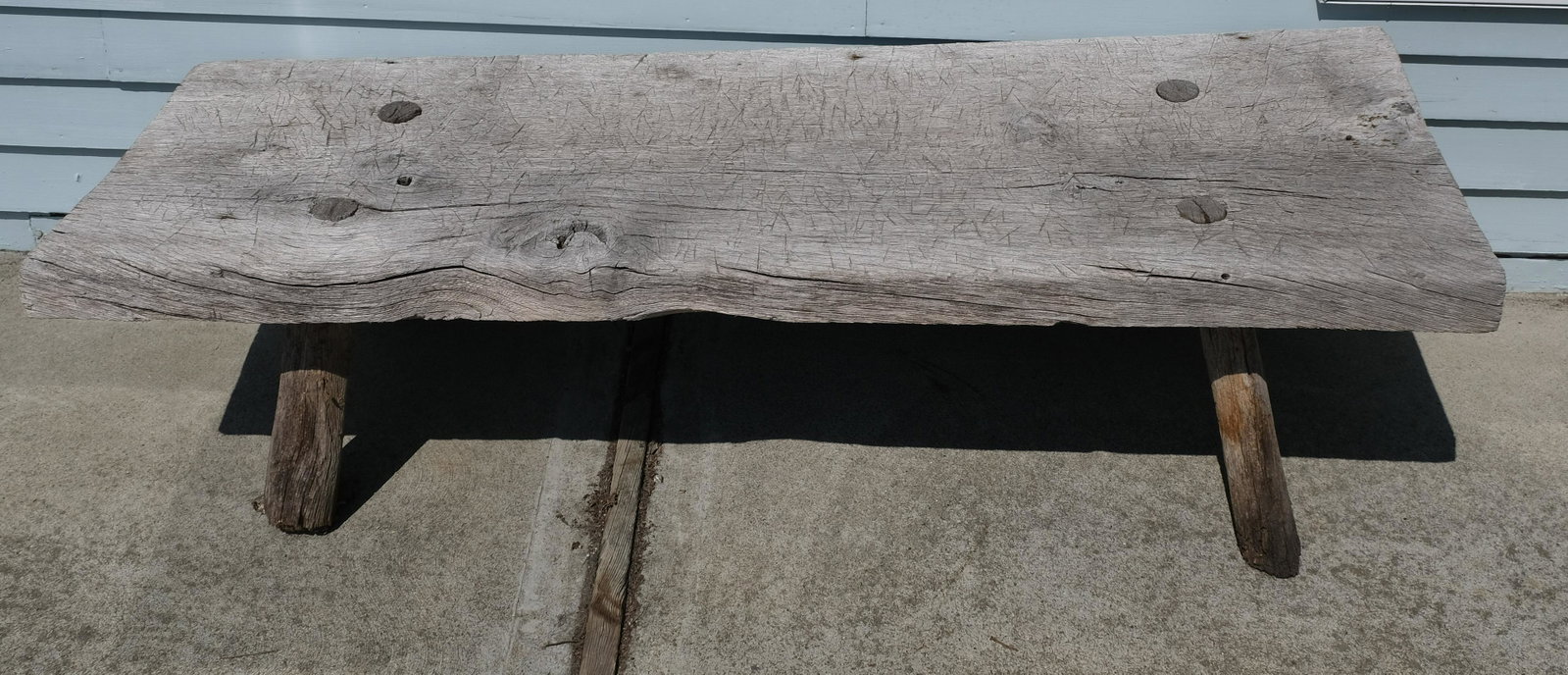 Teak Outdoor Low Bench: Hand Pegged legs in thick slab.14" tall, 59" wide, 20" deep.