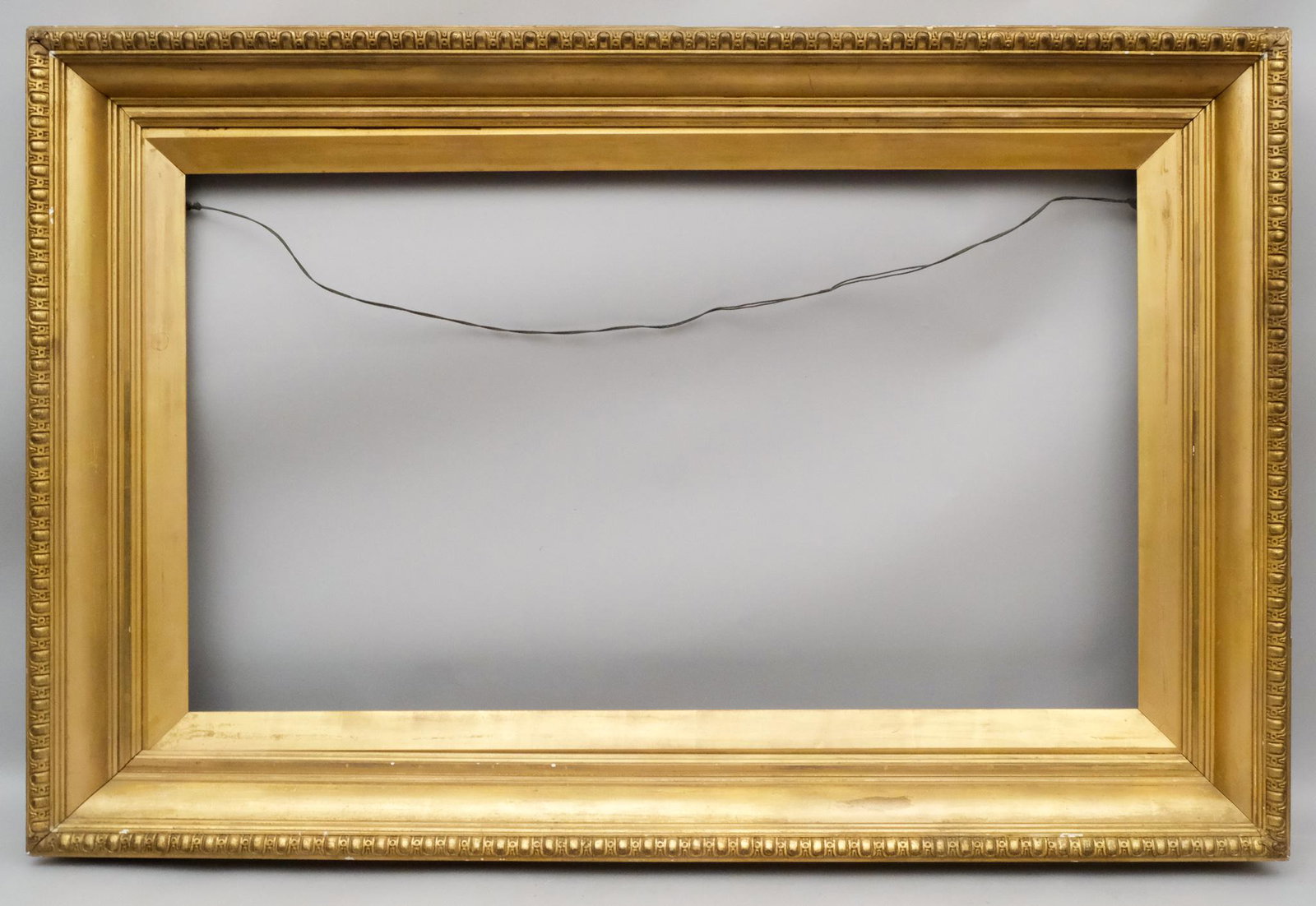 English Pre-Raphaelite Giltwood Frame: English ca. 1890, having a cushion profile with egg-and-dart top edge and lovely original gilding. Rabbet: 24" x 42" Overall Dimensions: 35 1/4" x 52 1/4" Molding Width: 6 1/4"