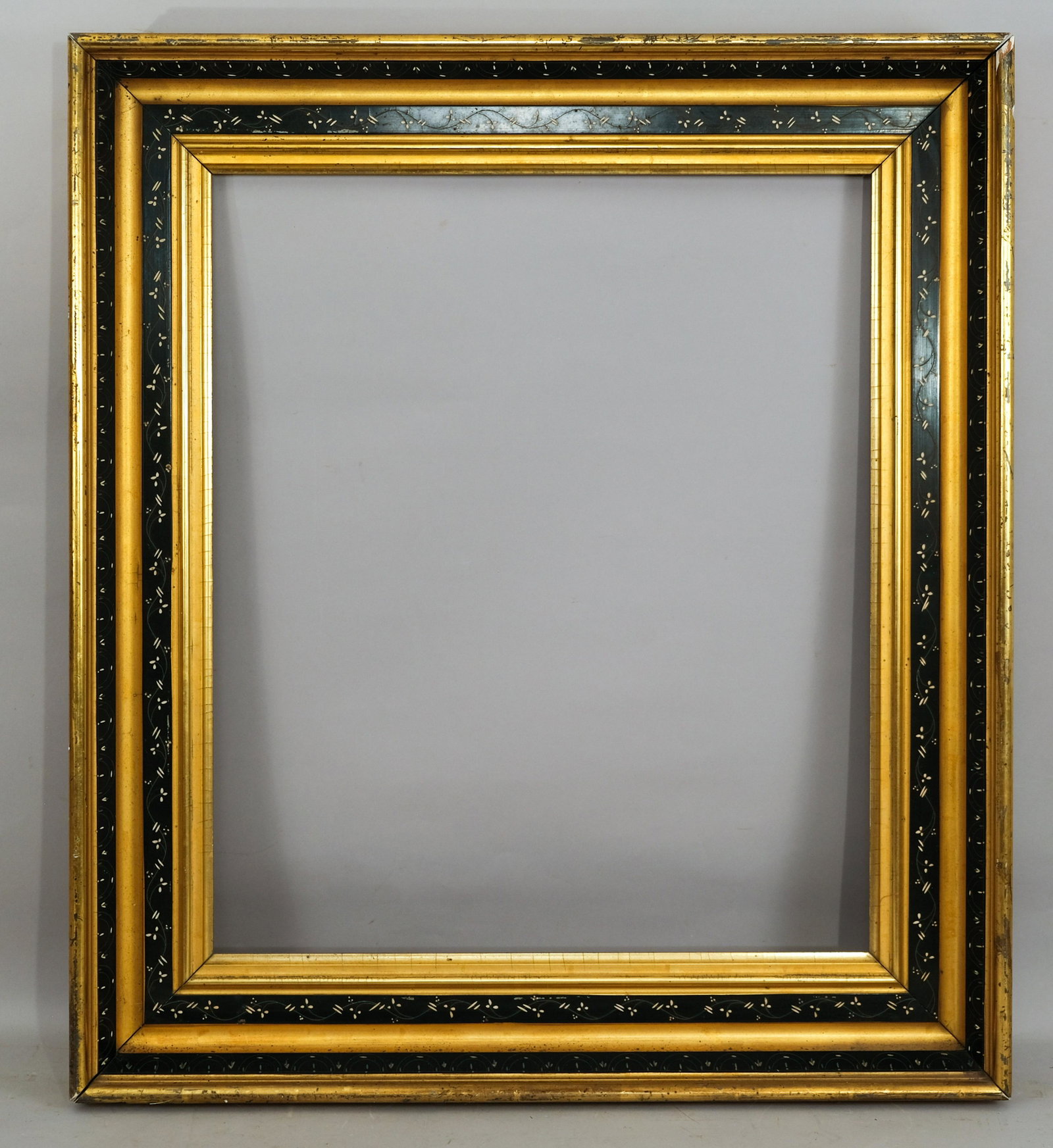 American Eastlake Lemon Gold and Ebonized Frame: American, ca. 1870, gilded with incised ebonized panel. Rabbet: 22" x 26" Overall Dimensions: 29 3/4" x 33 3/4" Molding Width: 4 1/4"