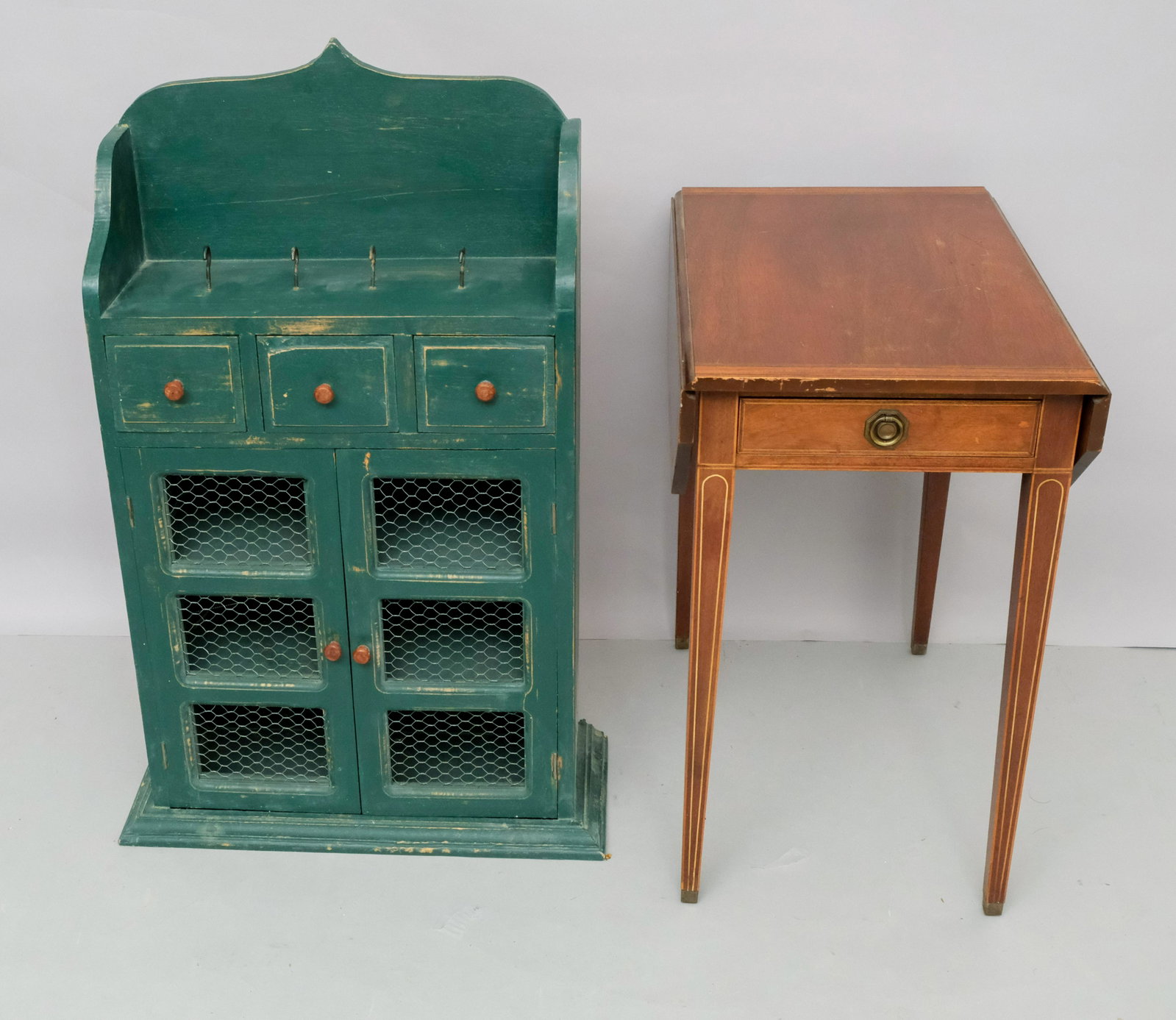 Green Spice Cabinet & Pembroke Table: Both 20th century, the table in the Hepplewhite style. Table measuring 16" x 24" x 27", width of 30" when leaves are extended. Cabinet measures 21" x 8" x 36".