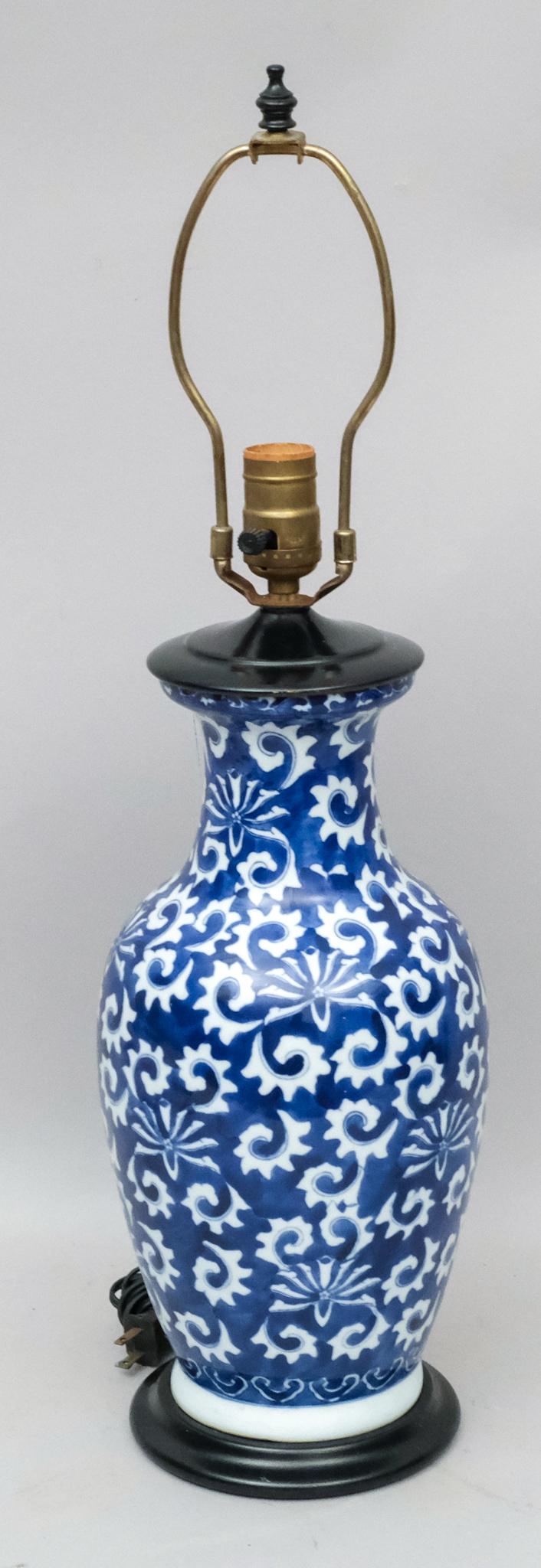 Chinese Blue and White Porcelain Lamp: Scrolling floral motifs with black base. 25" tall including harp.