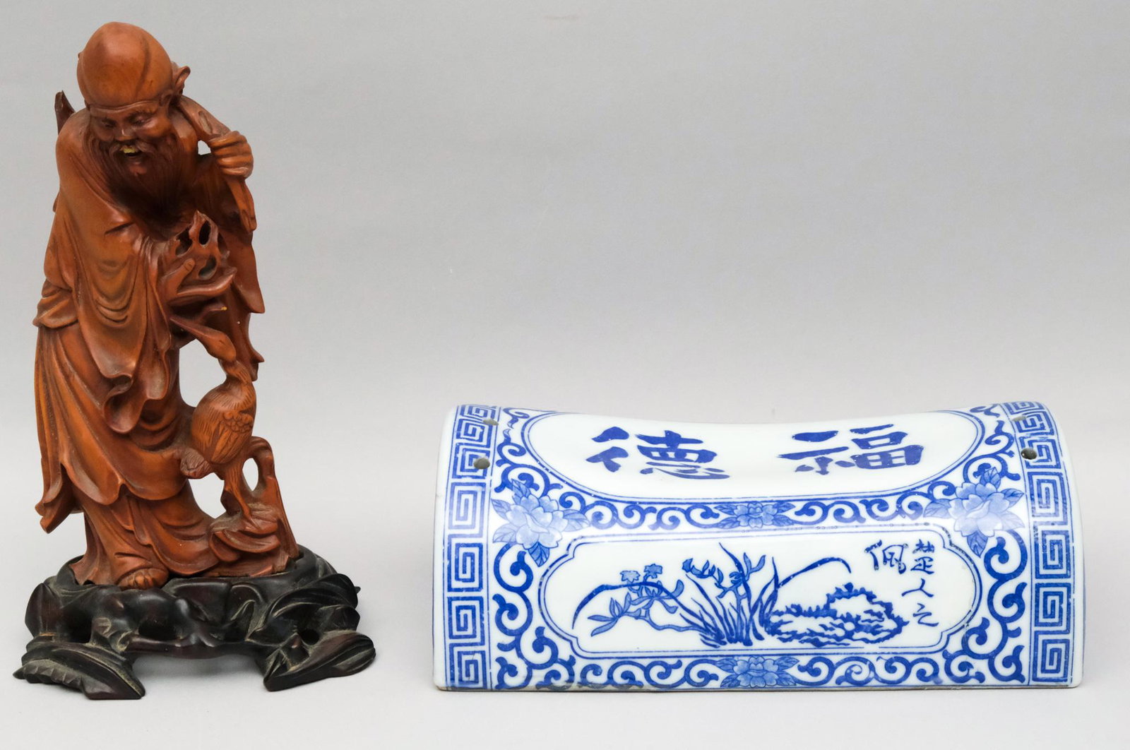 Group of Asian Antiques: Consisting of a wood carving of Shou Lao and a blue & white porcelain pillow form. height of carving 8 3/4"