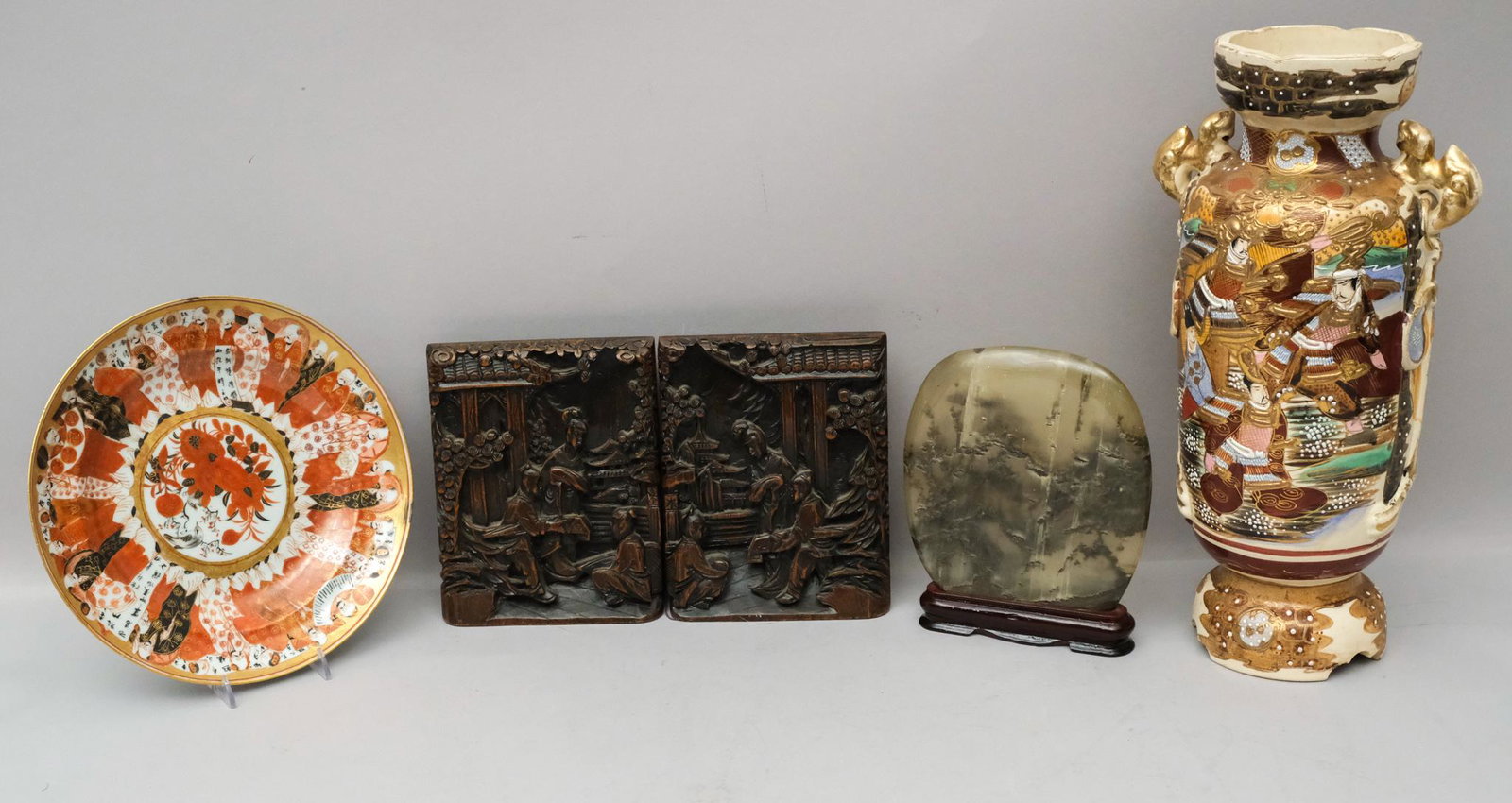 Lot of Asian Decorative Antiques: Including a stone sculpture, a plate with philosophers, a Satsuma vase, and a pair of carved wood bookends. Vase is 15" tall.