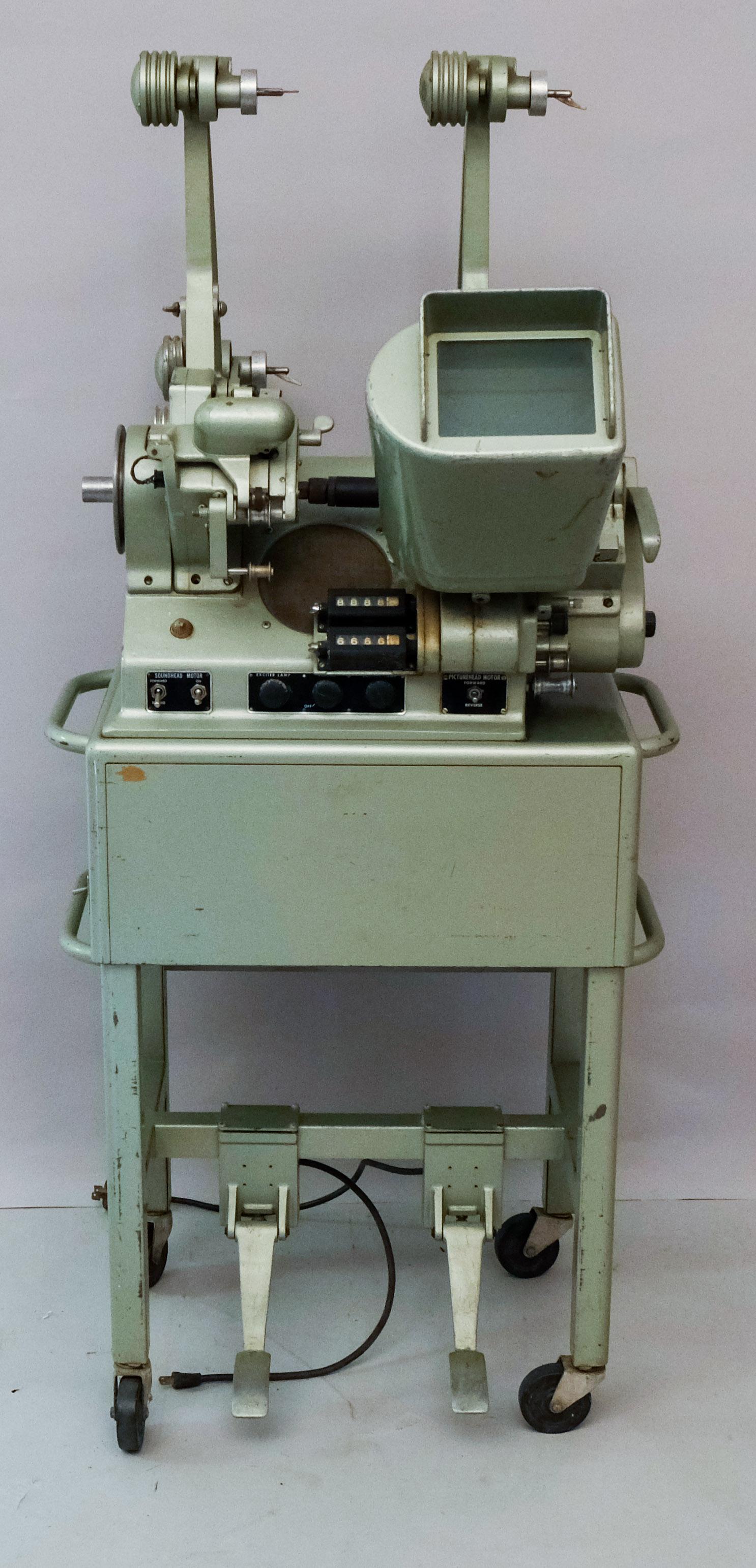 Moviola model L-20-H Film Editing Station: Studio used vintage Moviola model L-20-H mobile Film Editing Station. Serial number 47052. Beautiful metallic sea foam green exterior. 56" high X 26" deep x 29" wide
