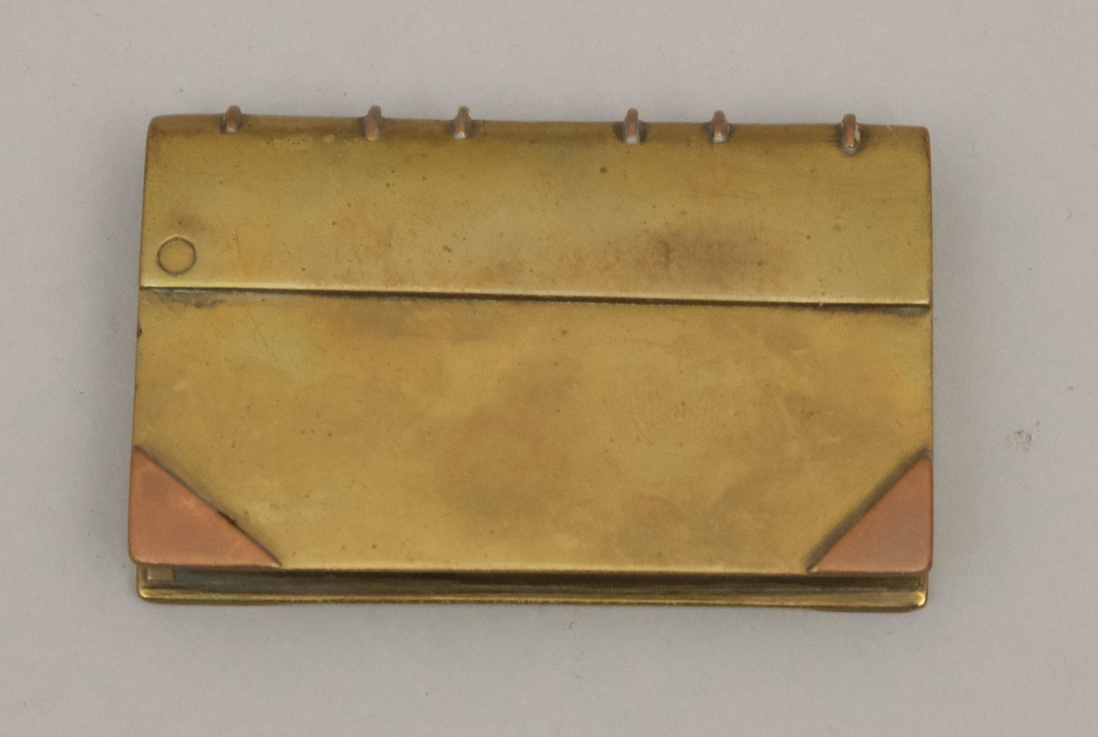 World War I Trench Art Brass Bookform Lighter: With copper corner and binding accents. 1 5/8" x 2 5/8".