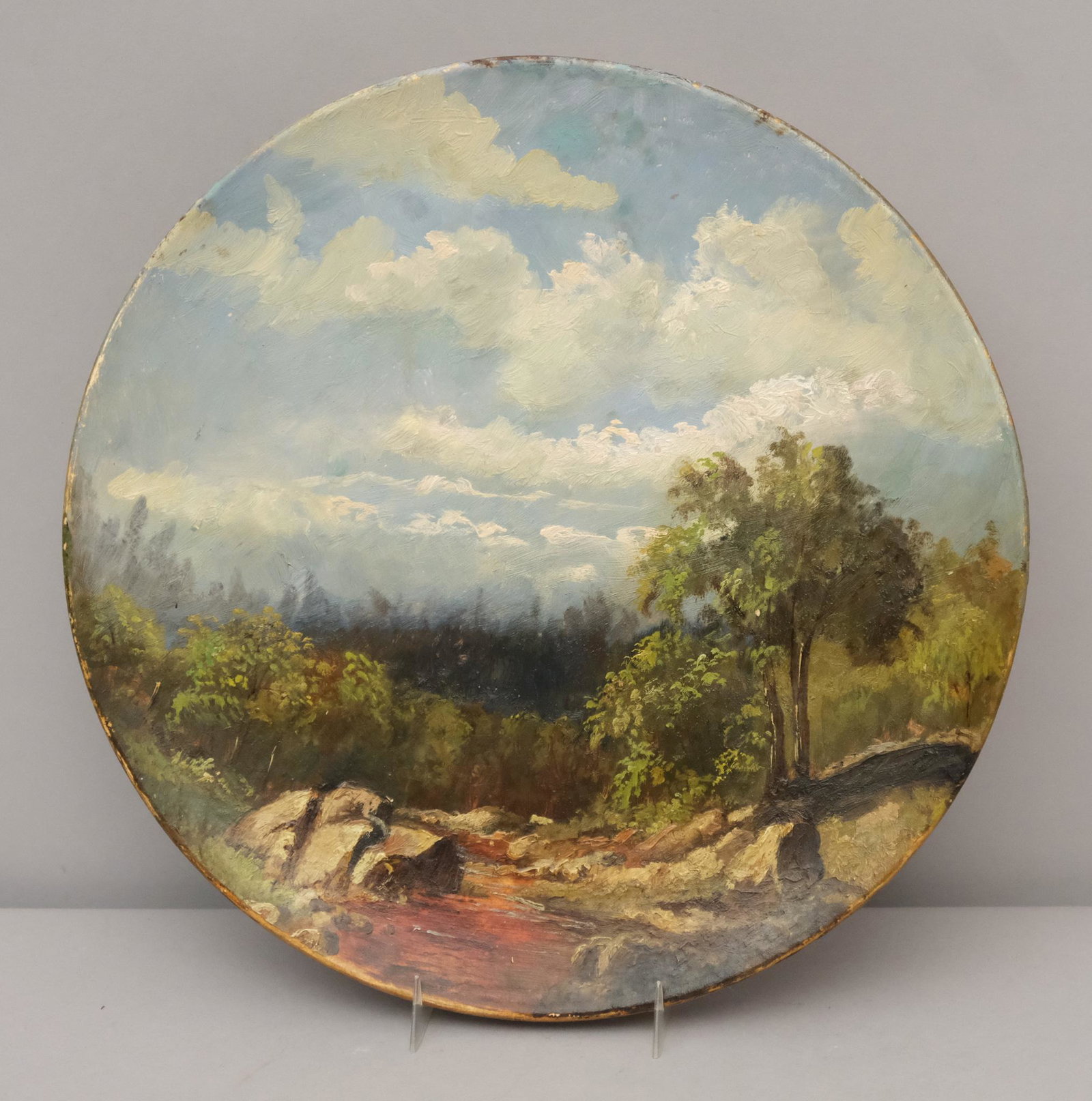 Hudson River School Painted Landscape Charger: Depicting a well executed landscape consisting of a rocky creek in the forest. Measuring: 12 3/4" diameter