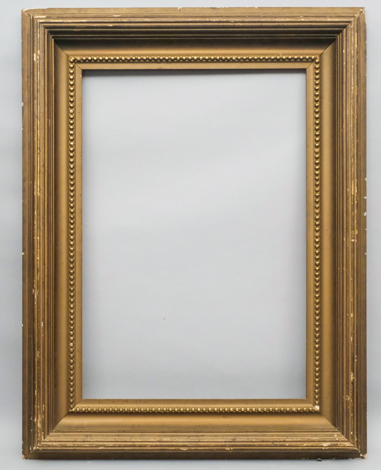 American Whistler Frame: American ca. 1890, reeded top edge with running pearls at sight edge, original Roman gilded surface. Rabbet: 27" x 39 1/2", overall: 40 1/2" x 52 1/2", molding: 7"