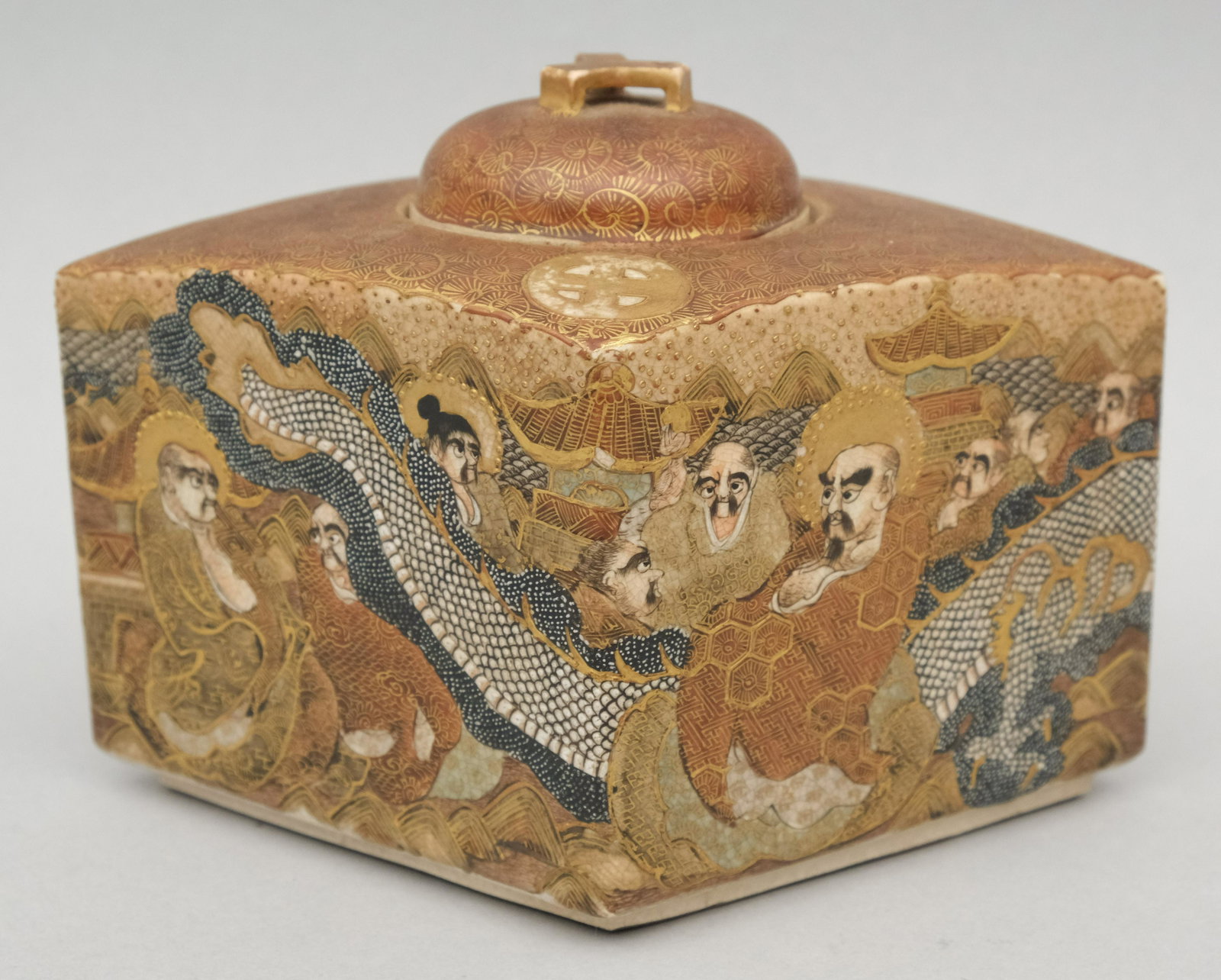 Diamond Form Satsuma Porcelain Tea Caddy: Decorated with philosophers or monks and a bold flying dragon. Character mark on bottom. 4 1/2" x 6 6 3/4".